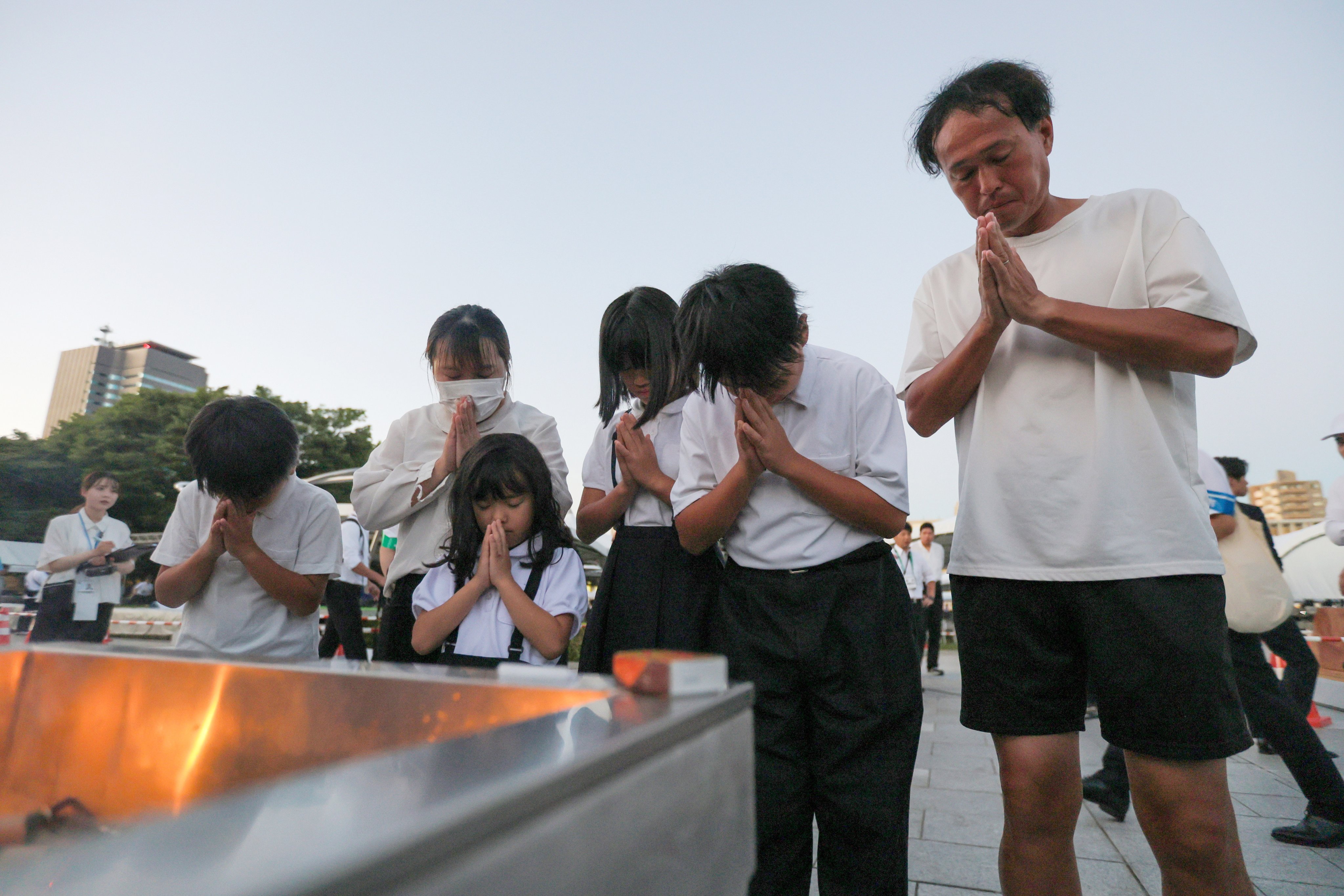 People offer prayers for the victims ahead of the Peace Memorial Ceremony on the 81st anniversary of the atomic bombing of Hiroshima at Peace Memorial Park in Hiroshima. Photo: EPA/JIJI Press