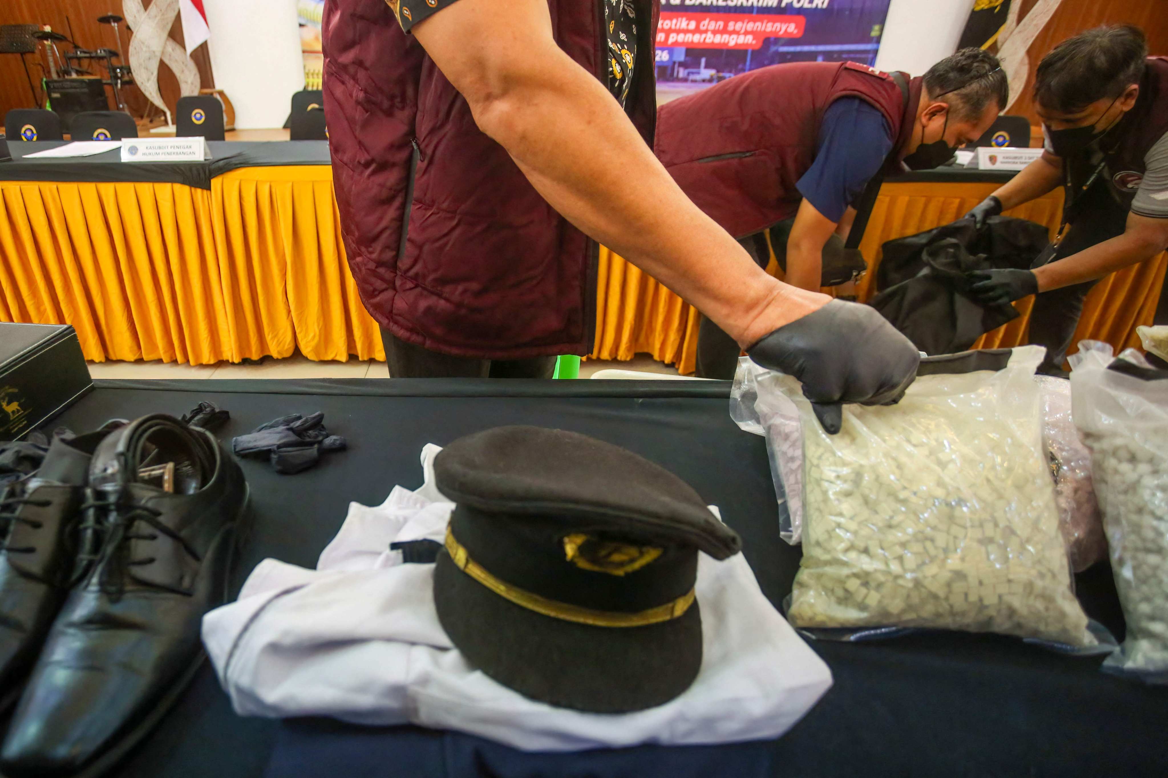 Indonesian Customs officials prepare to display the evidence seized from a Malaysian pilot at Soekarno-Hatta International Airport on July 31. Photo: AFP