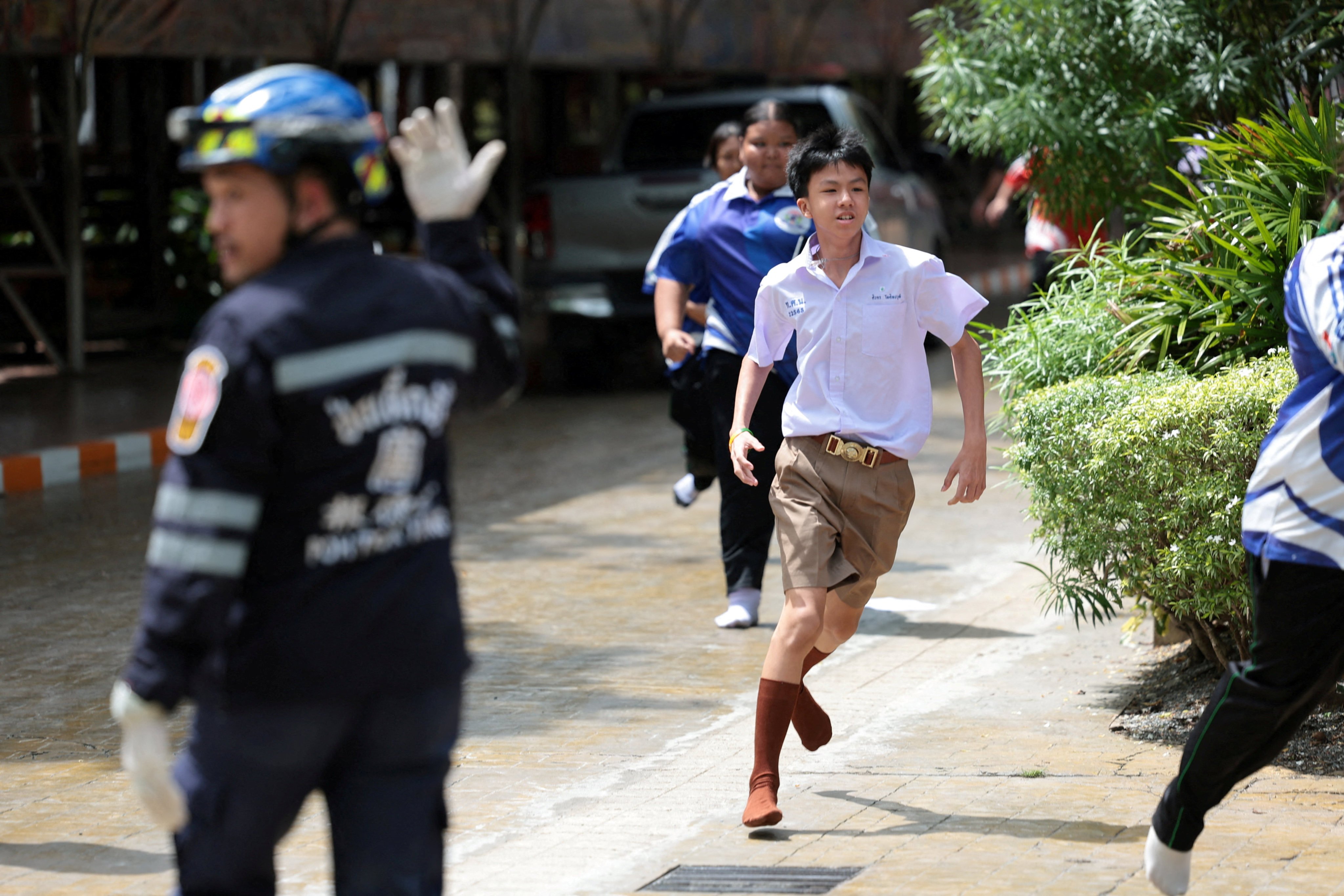 Students run following a shooting at a school in Nonthaburi province, Thailand, on Friday. Photo: Reuters
