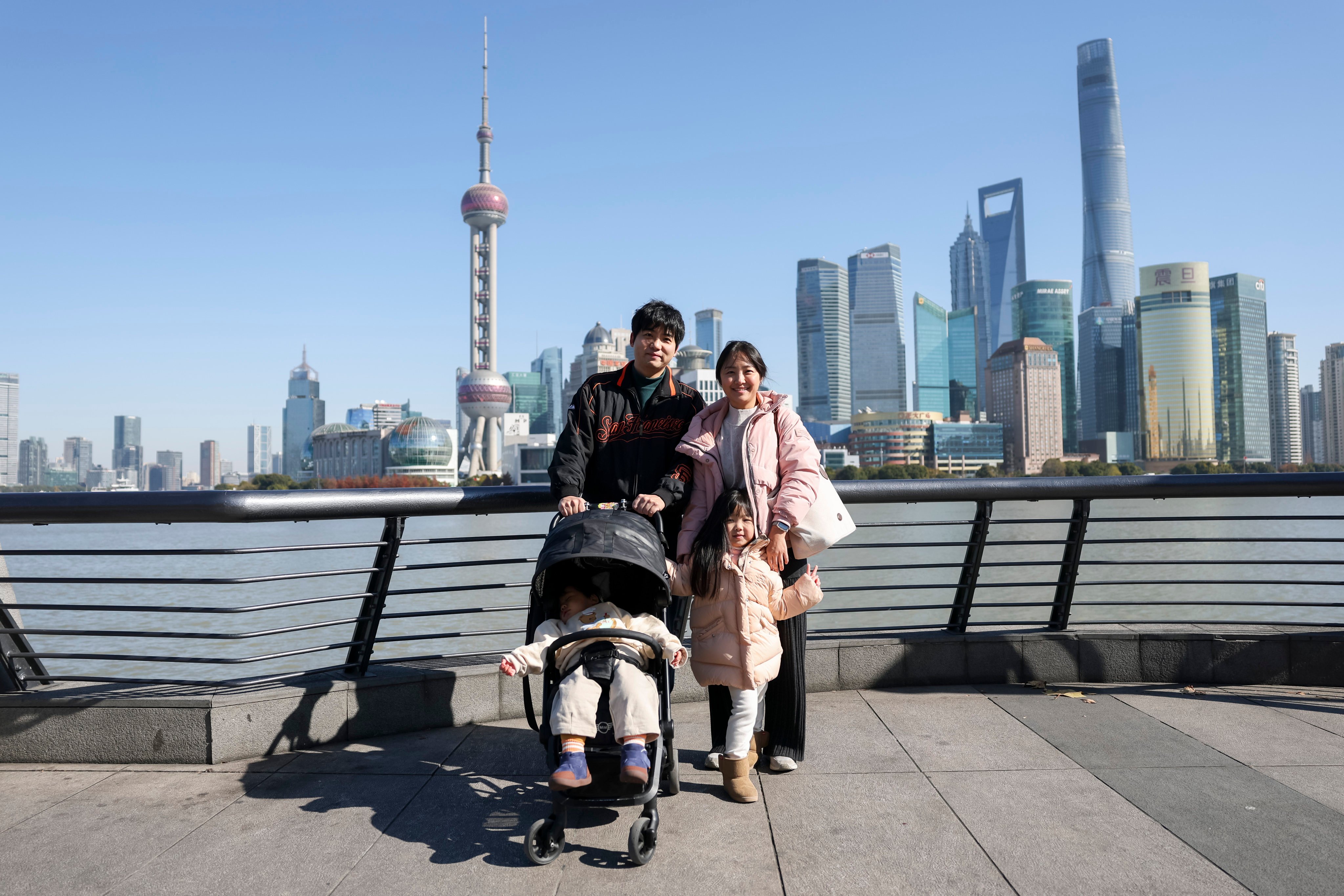 South Korean tourists pose for photos at the Bund in Shanghai. Photo: Xinhua