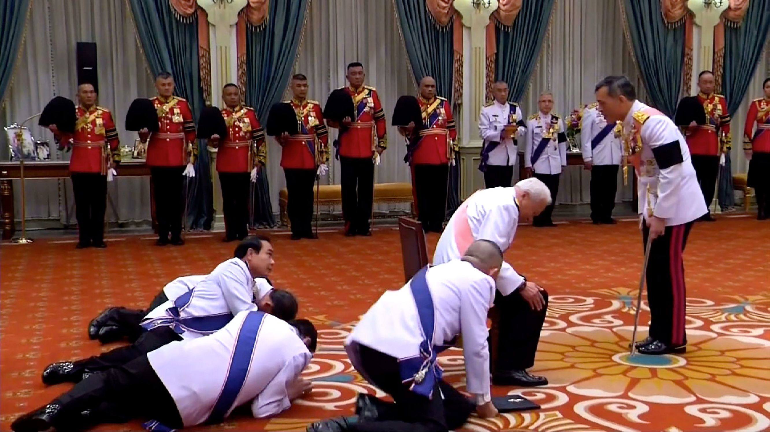 Then Thai prime minister Prayuth Chan-Ocha (middle left) prostrates himself in front of newly appointed Thai King Vajiralongkorn in 2016. Photo: AFP