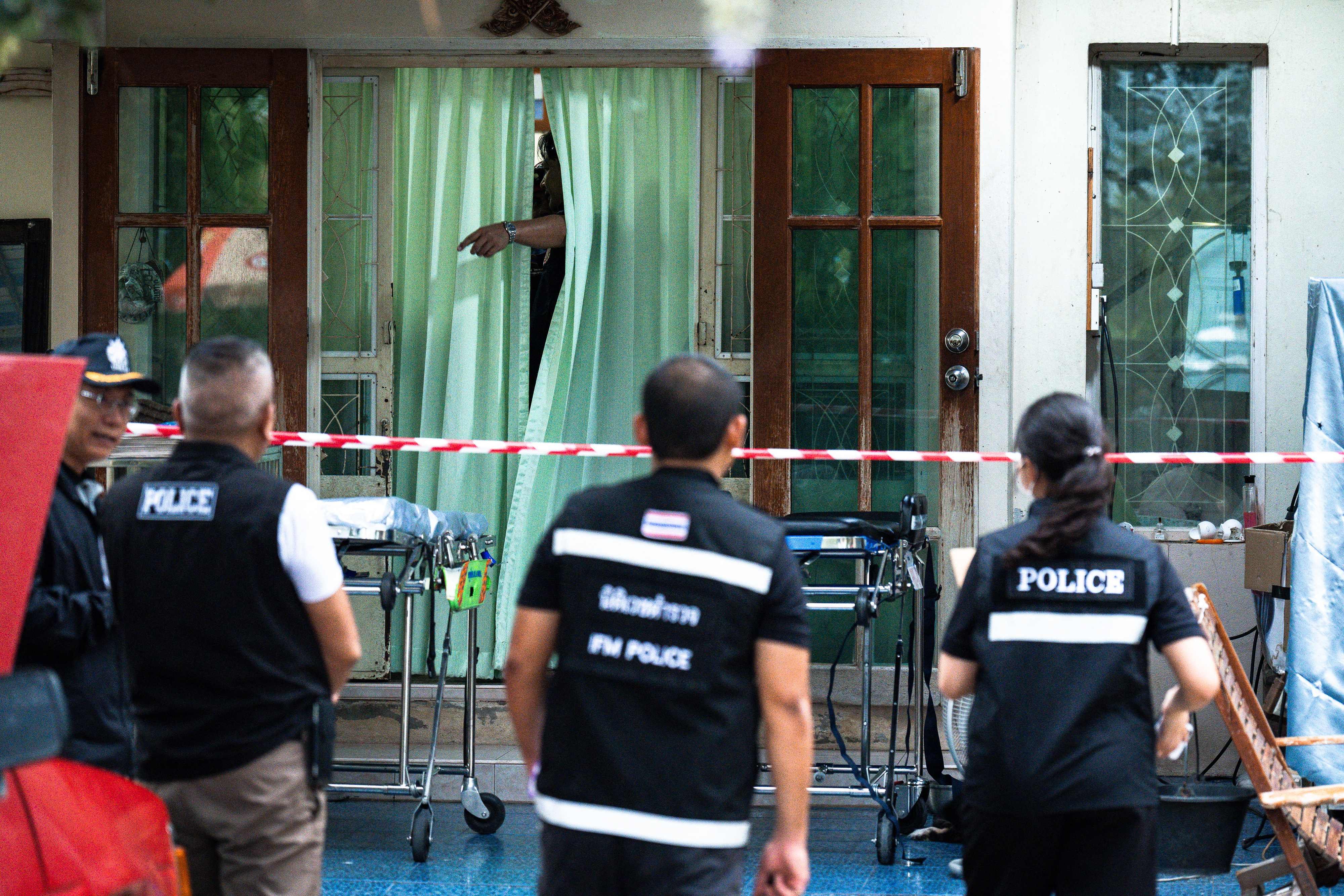 Police gather outside the house where a teenage suspect is suspected of killing his grandparents before carrying out a school shooting in Thailand’s Nonthaburi province on Friday. Photo: AFP