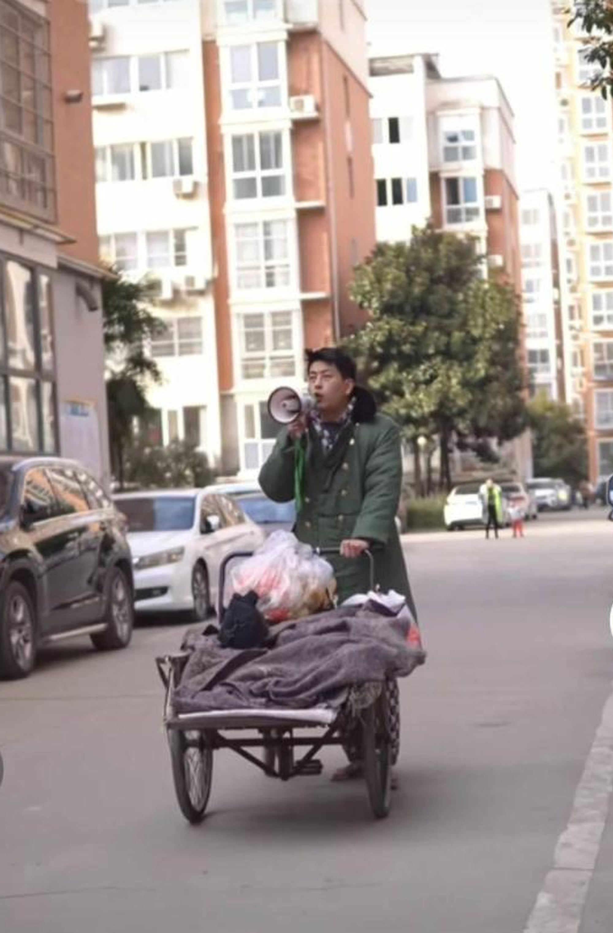 In his videos, Yan typically wears a scruffy overcoat, pulls a cart, and wields a loudhailer. Photo: news.china.com In his videos, Yan typically wears a scruffy overcoat, pulls a cart, and wields a loudhailer. Photo: news.china.com