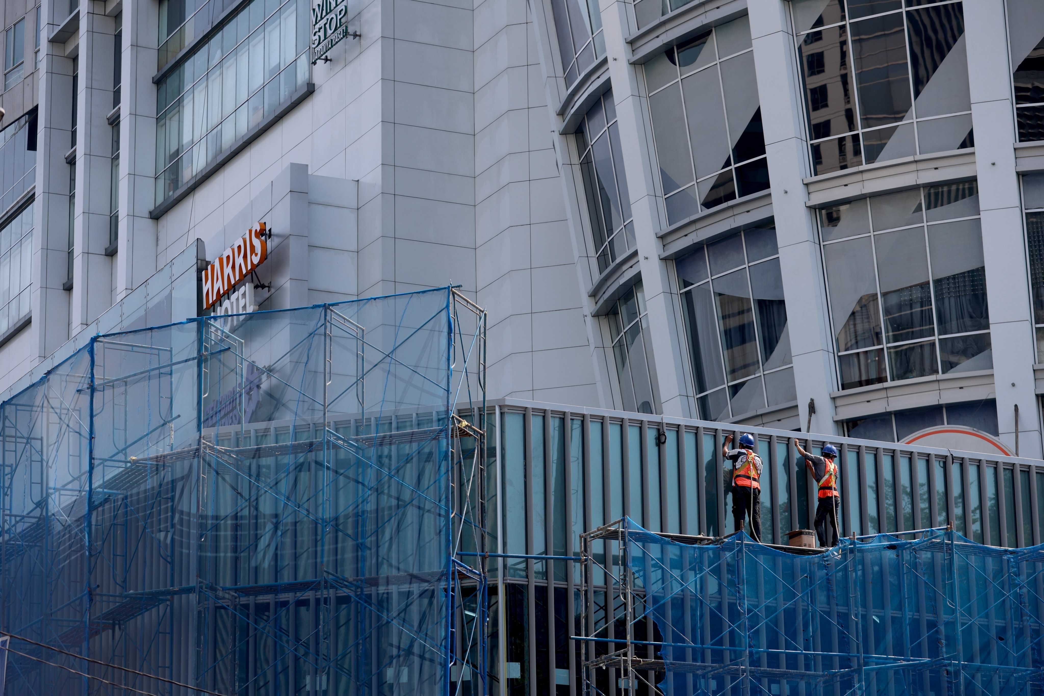 Labourers work at a construction site in Jakarta. Photo: EPA
