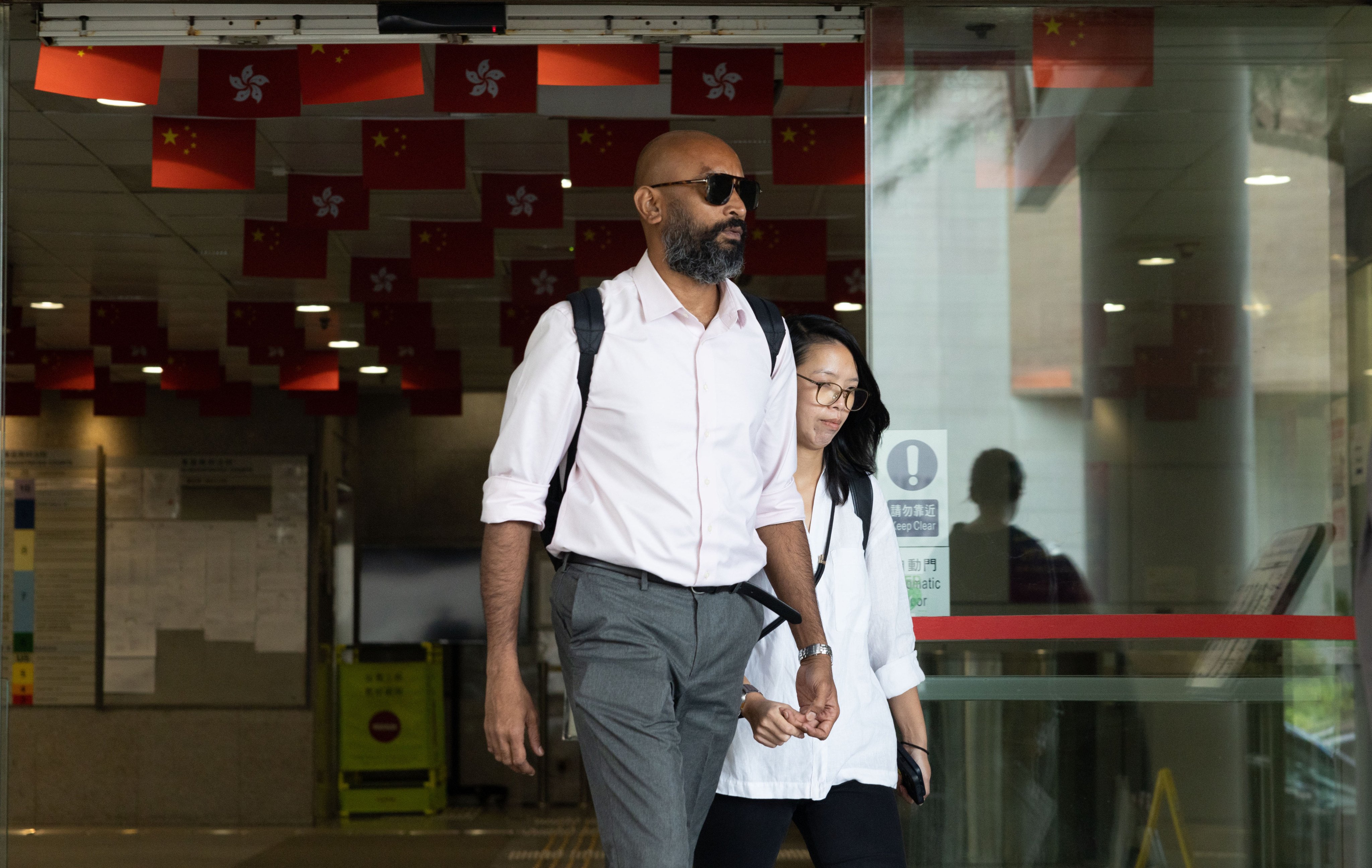 Virologist Vijaykrishna Dhanasekaran leaves Eastern Court after a hearing in June 2026. Photo: Brian Wong