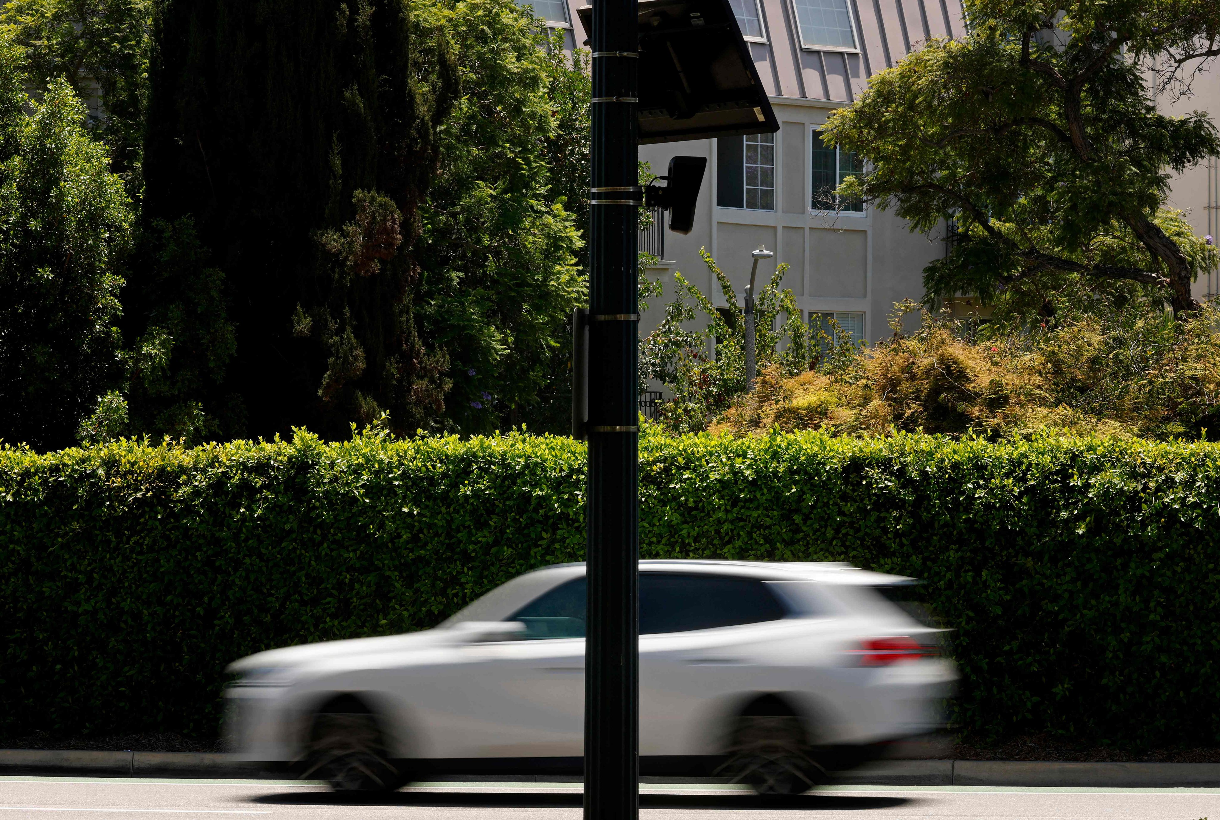 A car drives by a Flock Safety camera mounted to a light pole in Beverly Hills, California. Photo: Getty Images via AFP