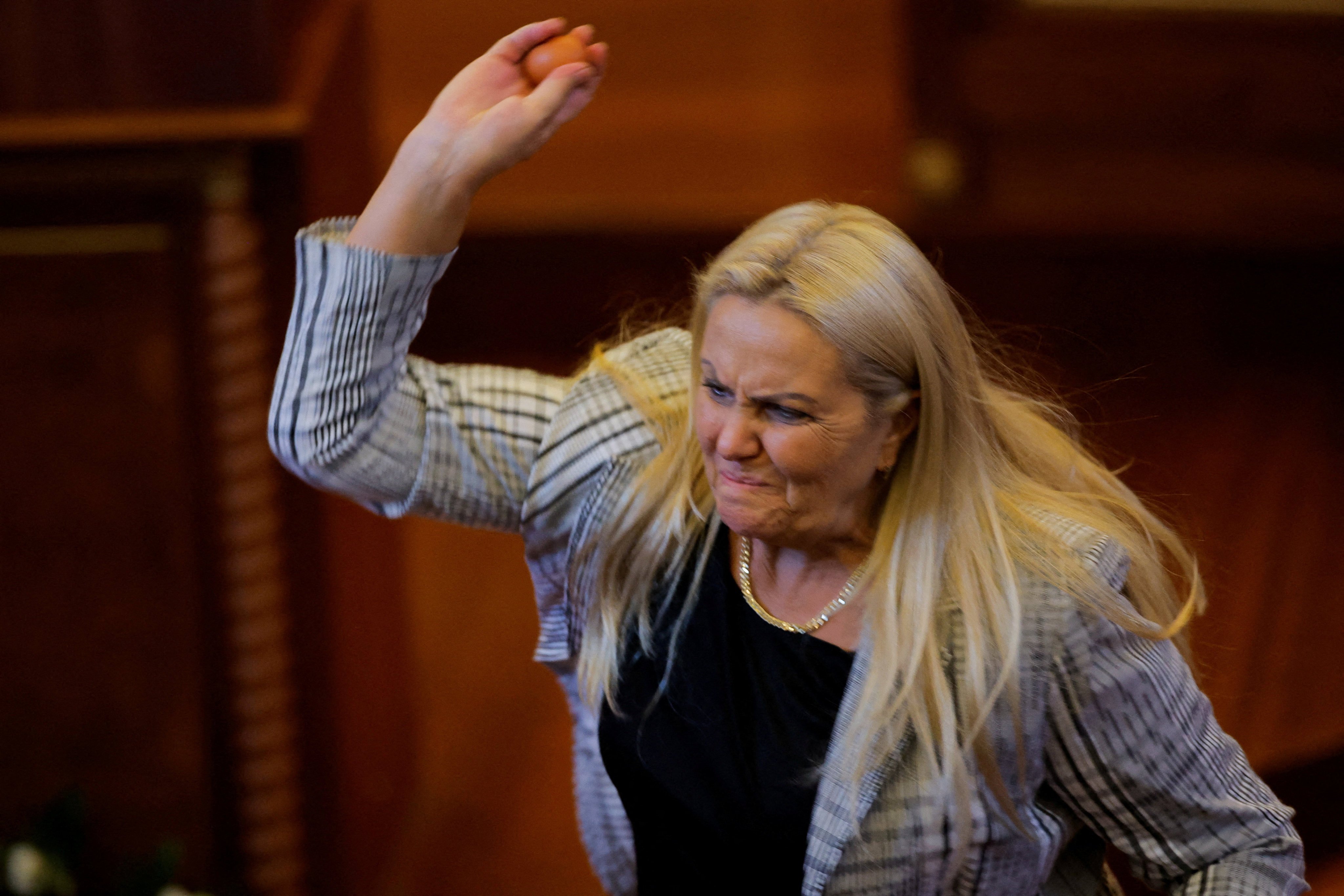 Opposition lawmaker Time Kadrijaj throws an egg at Prime Minister Albin Kurti (not pictured) during a plenary session to elect the new speaker of the parliament, in Pristina, Kosovo, on Saturday. Photo: Reuters