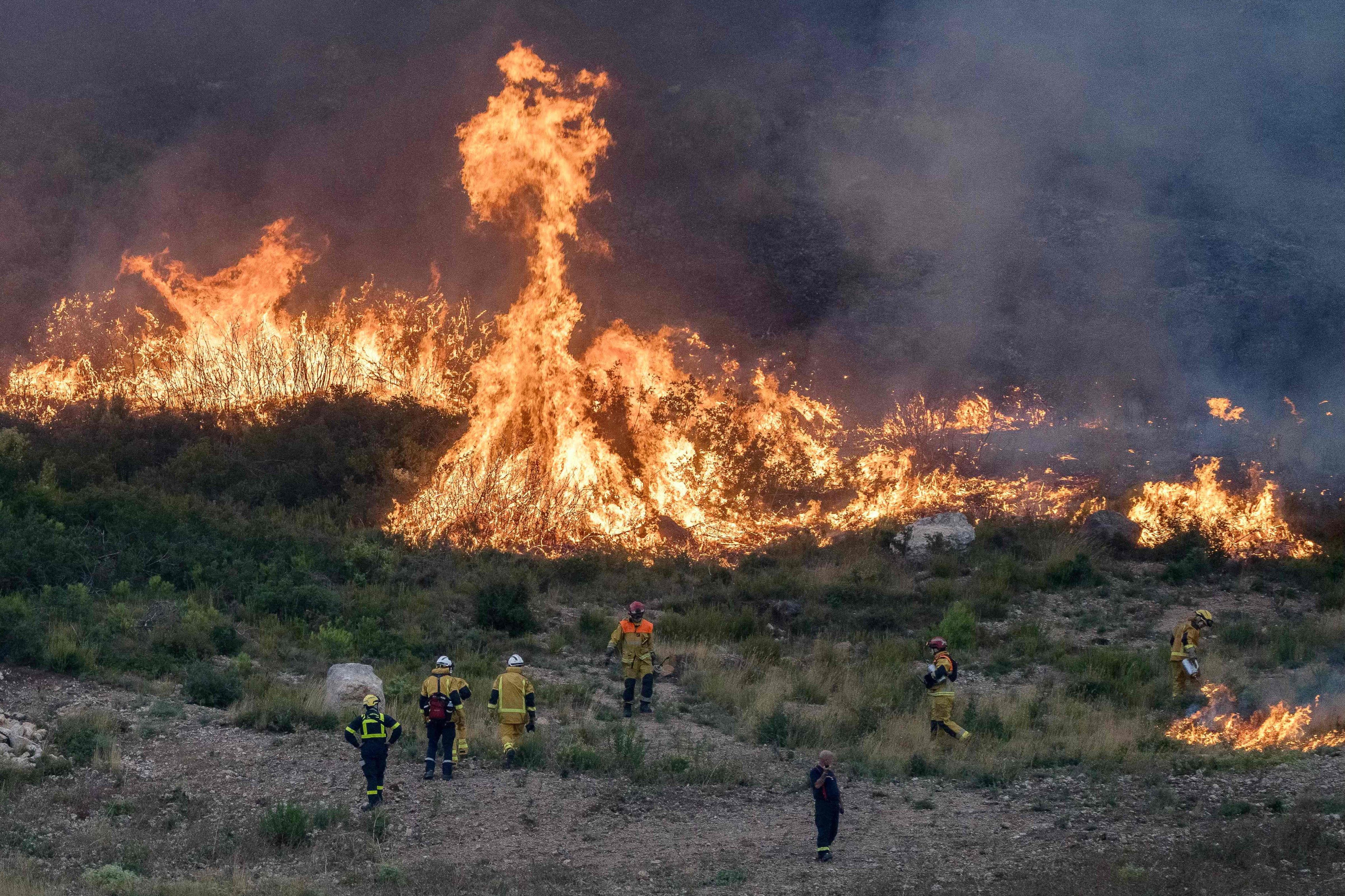 Firefighters work to extinguish a wildfire in the Corbieres massif near Saint-André-de-Roquelongue, south-western France on Thursday. On Sunday, a fast-moving fire in the Lozere region forced evacuations. Photo: AFP