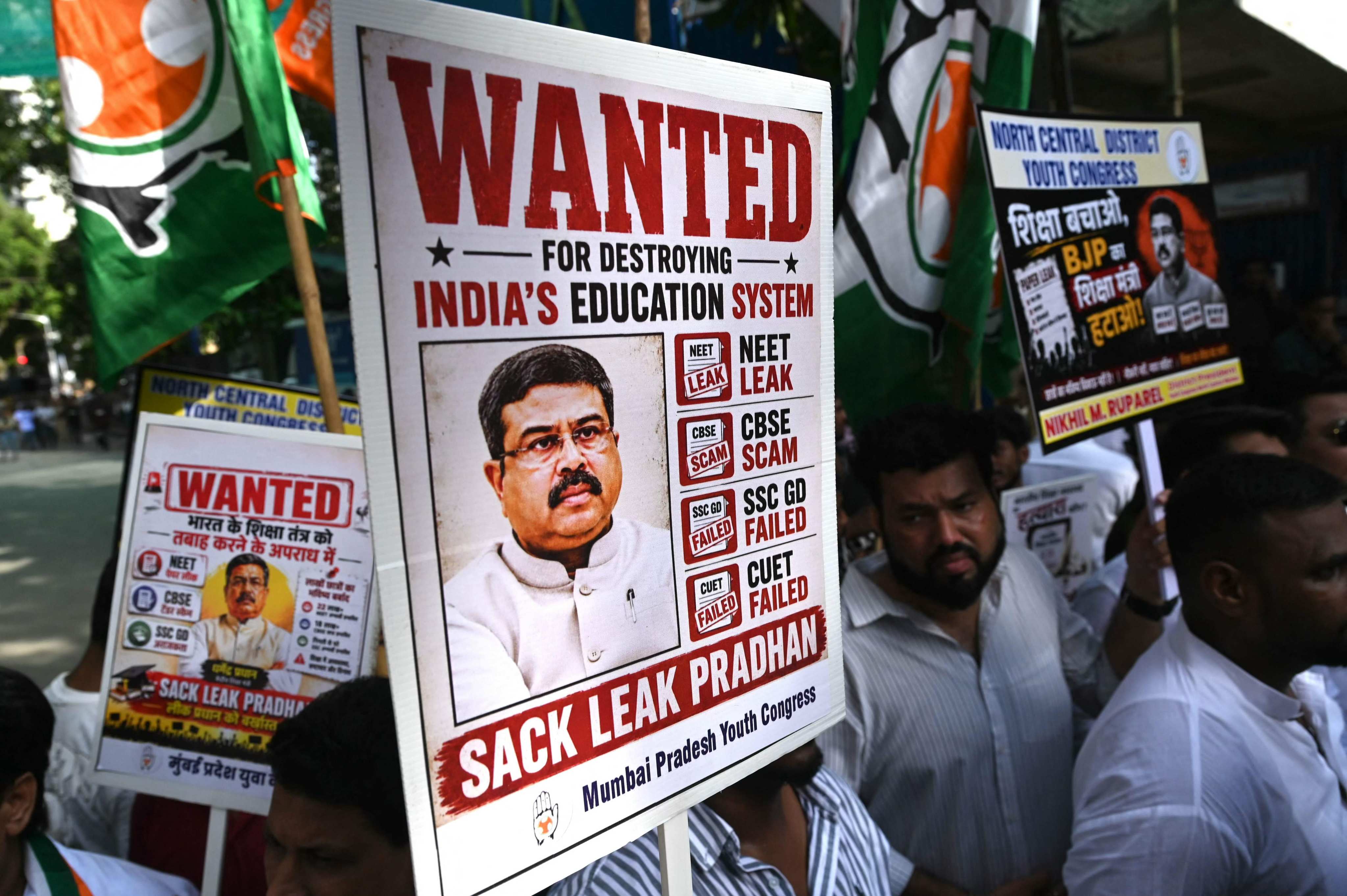 Indian Youth Congress party workers hold placards featuring India’s education minister Dharmendra Pradhan during a protest over the alleged national medical school entrance exam irregularities, in Mumbai on June 2. In July, Pradhan announced his resignation after countrywide protests. Photo: AFP