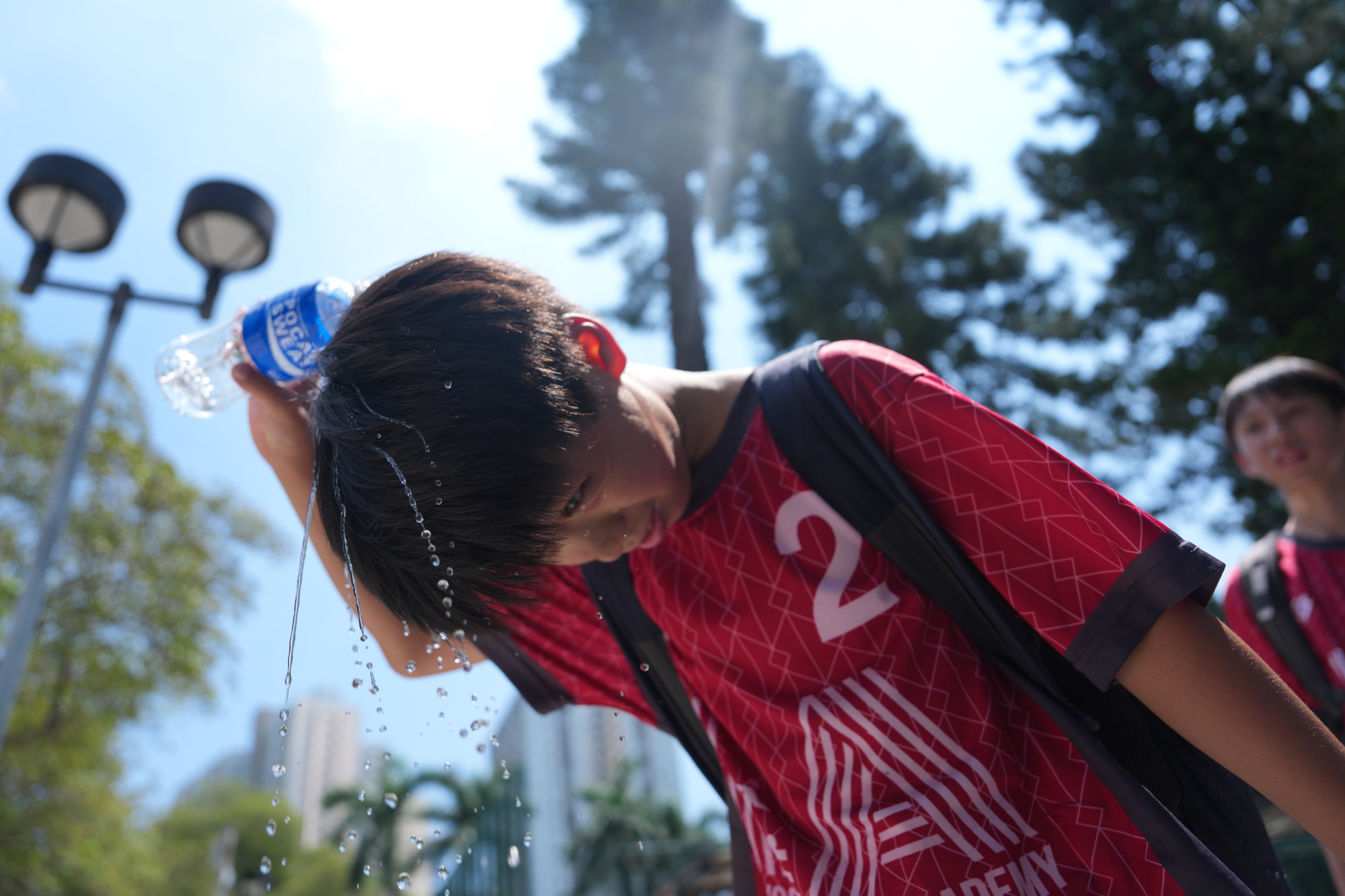 A boy pour water over his head under the extreme hot weather at Morse Park at Wong Tai Sin.     10AUG26 SCMP/ Sam Tsang