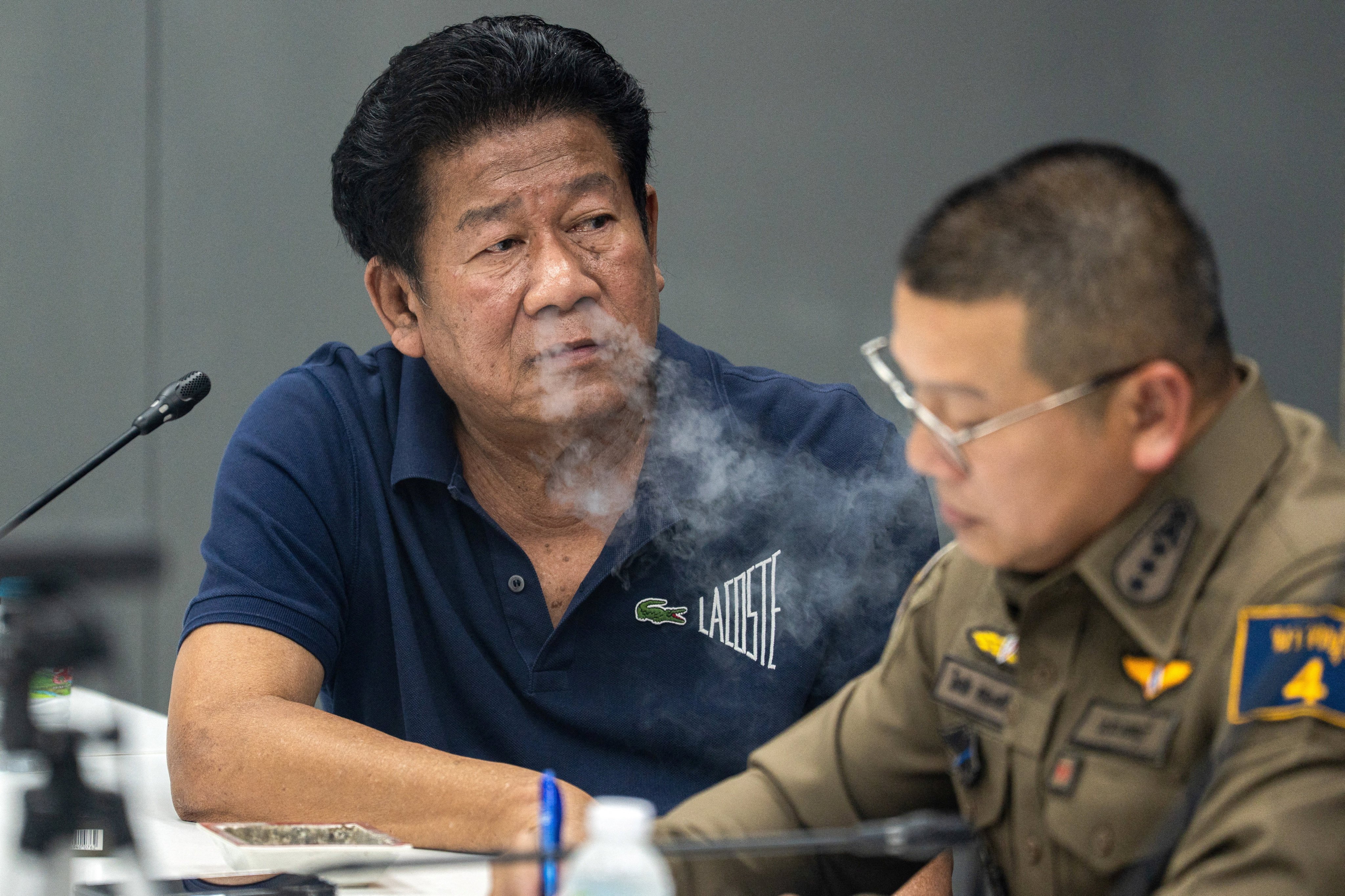 Former MP Chalong Riewrang is questioned by police after he allegedly shot and killed provincial official Thongchai Yenprasert on the outskirts of Bangkok on Monday. Photo: Reuters