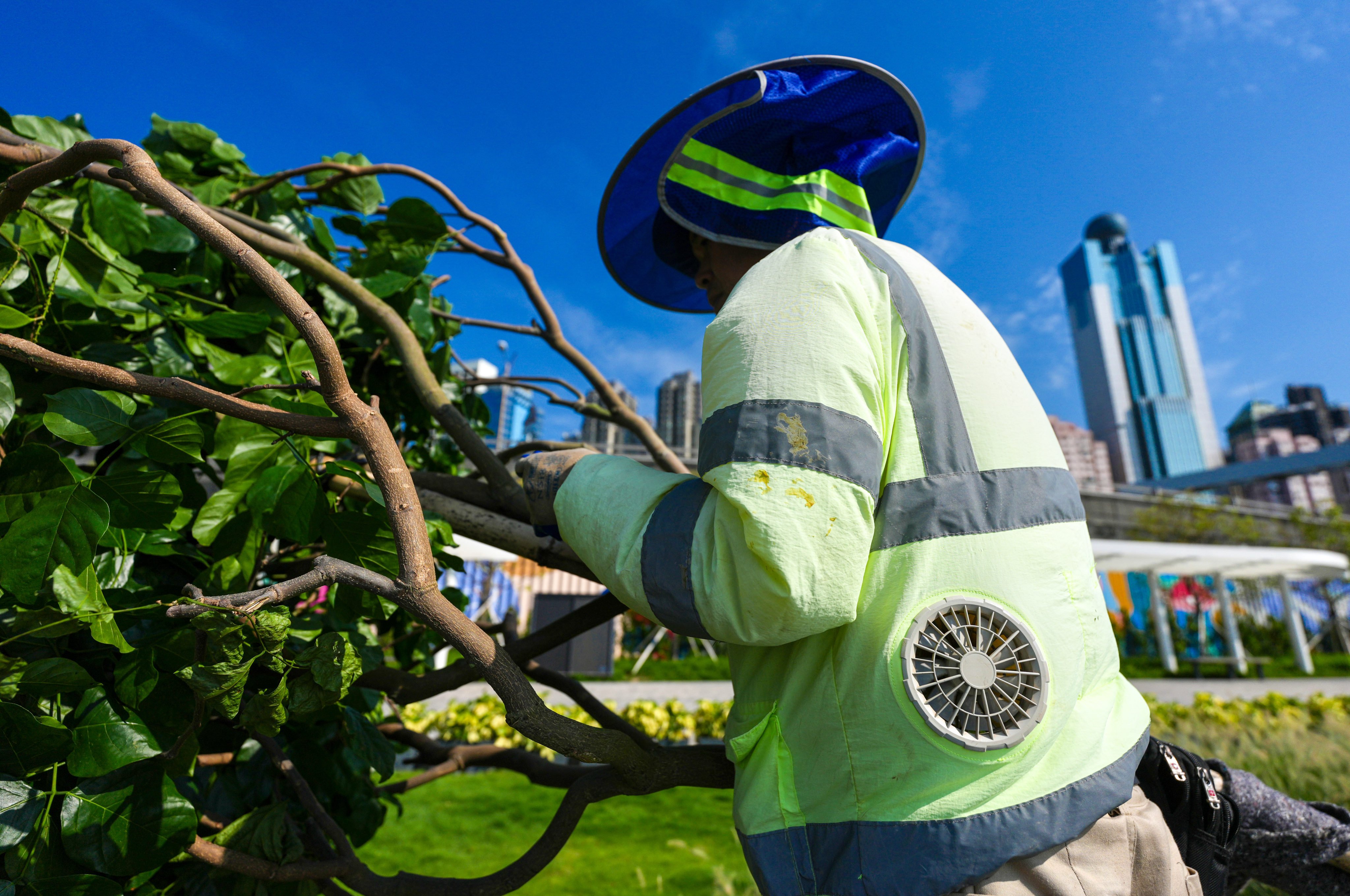 A worker wears a cooling vest while planting trees at Sai Ying Pun Harbourfront Park in June. Photo: Karma Lo