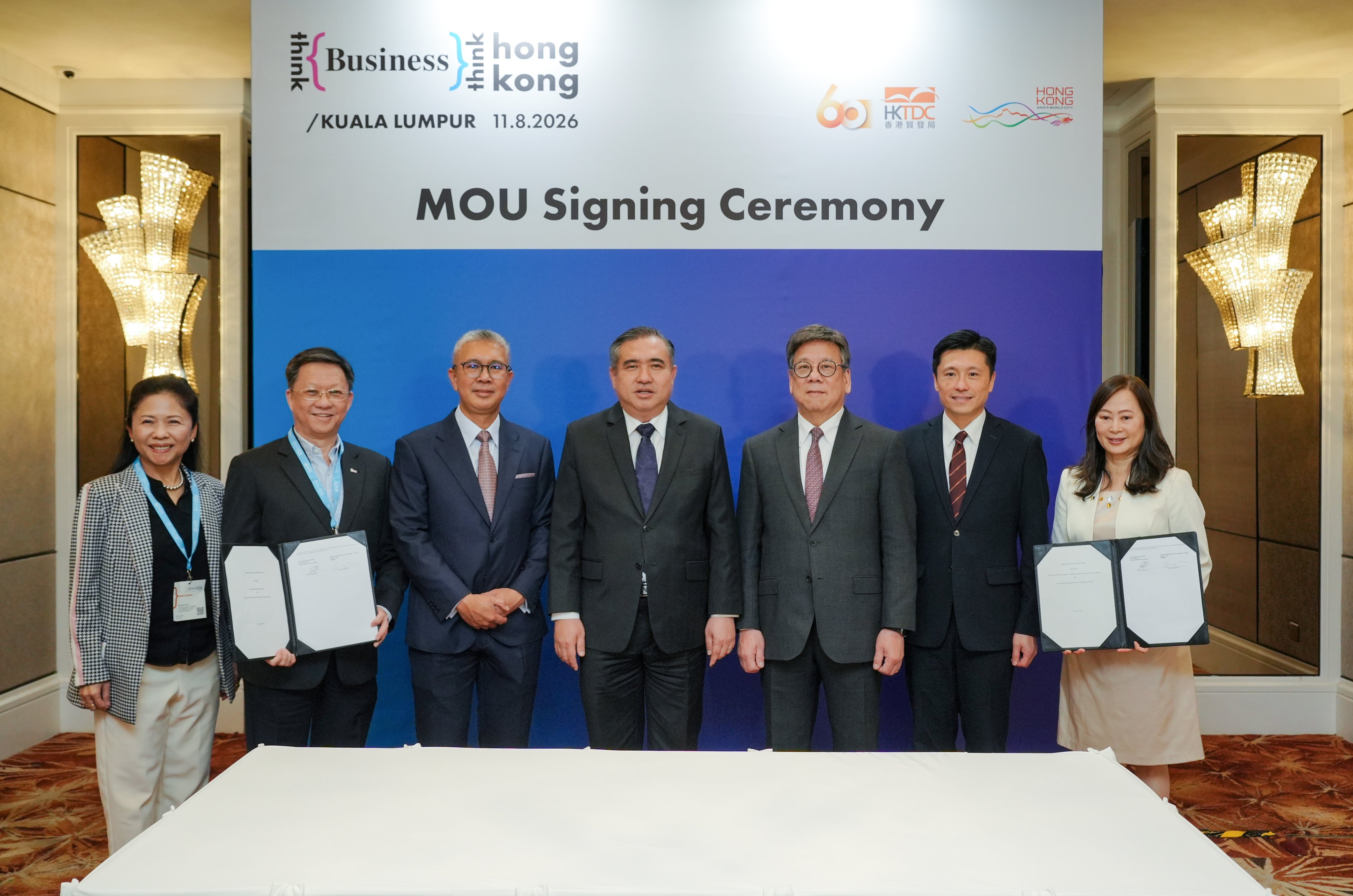 Secretary for Commerce and Economic Development Algernon Yau (third from right), Director of Information Services John Tse (second from right) and SCMP publisher Tammy Tam (right) at the MOU-signing ceremony in Kuala Lumpur. Photo: Handout