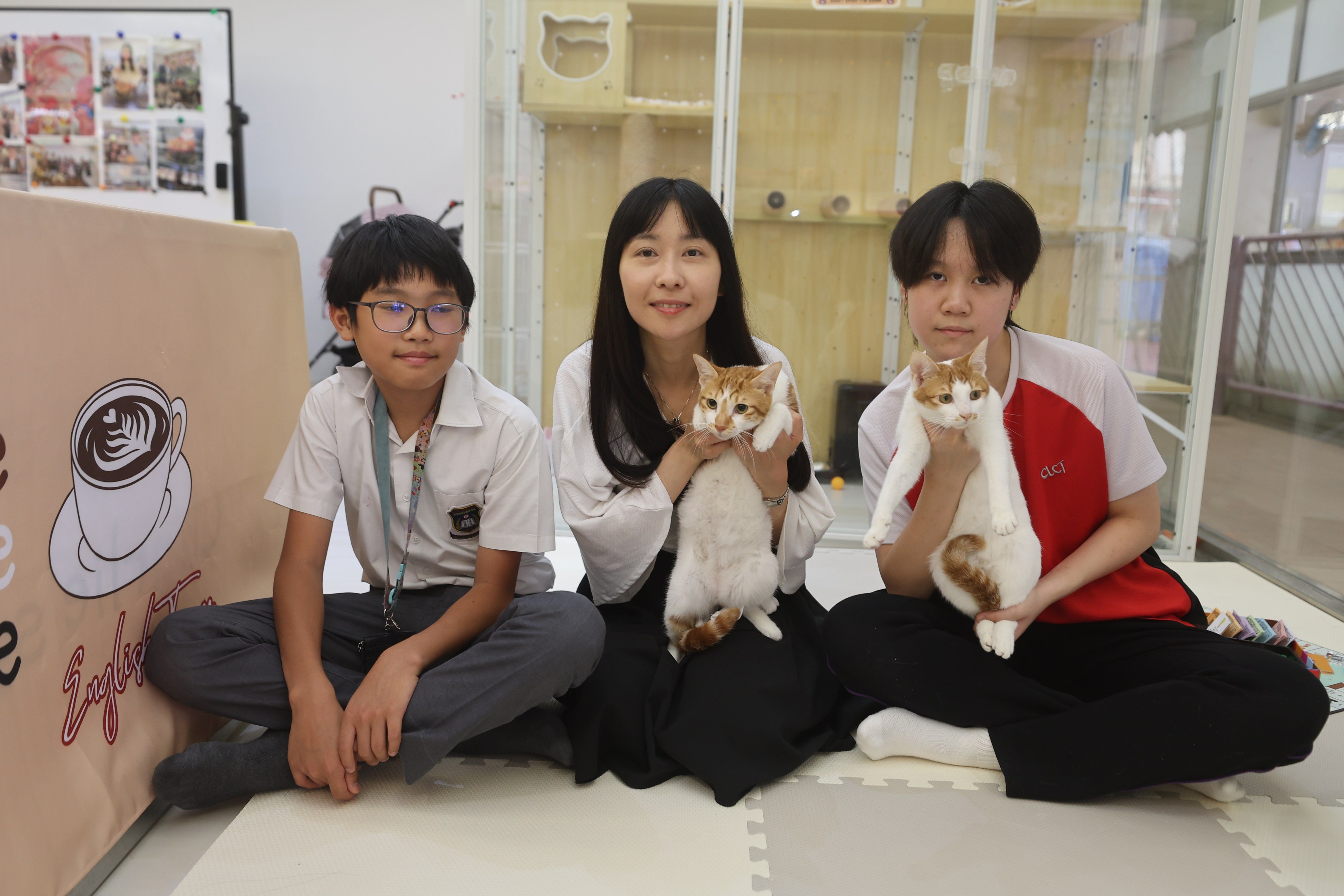Hei Hei Chan (left) and Yanis Tsang (right) are
regular visitors to their school’s cat cafe, started by the English panel head for junior forms, Yen Chan. Photo: Edmond So