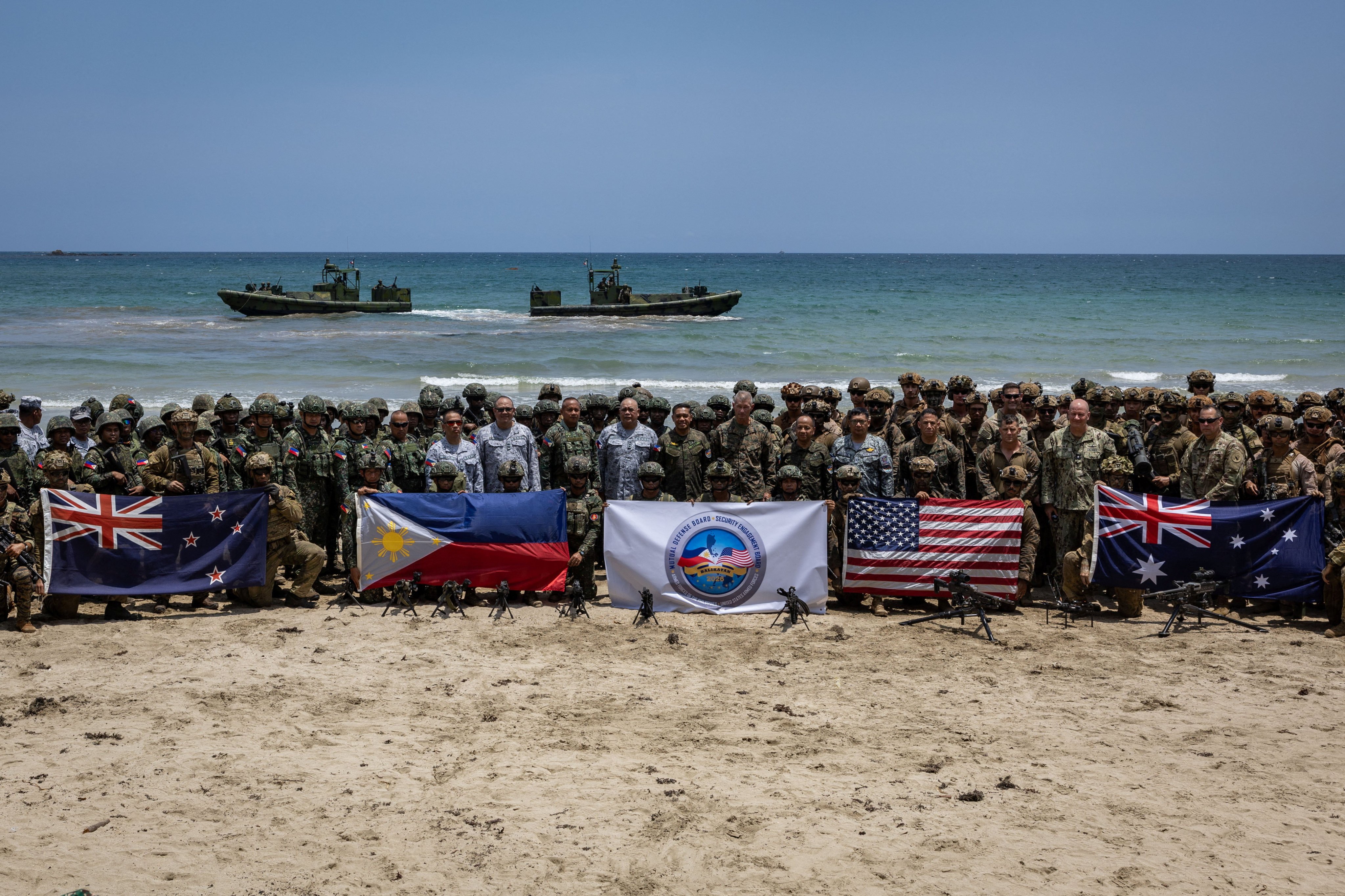 Troops from New Zealand, Philippines, the US and Australia pose with their national flags after taking part in live-fire exercises in the Philippines. Photo: Reuters