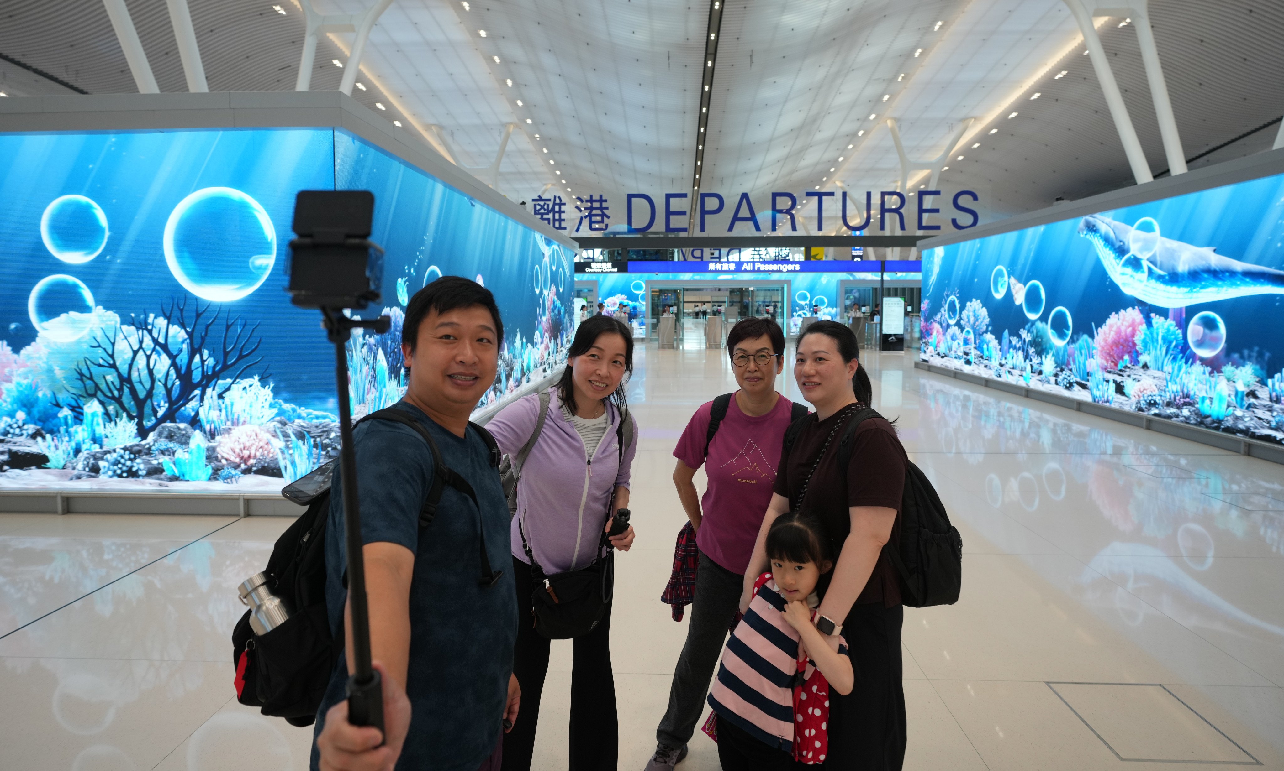 Passengers pose for pictures at Hong Kong International Airport in Chek Lap Kok on May 27. Photo: SCMP/Sam Tsang