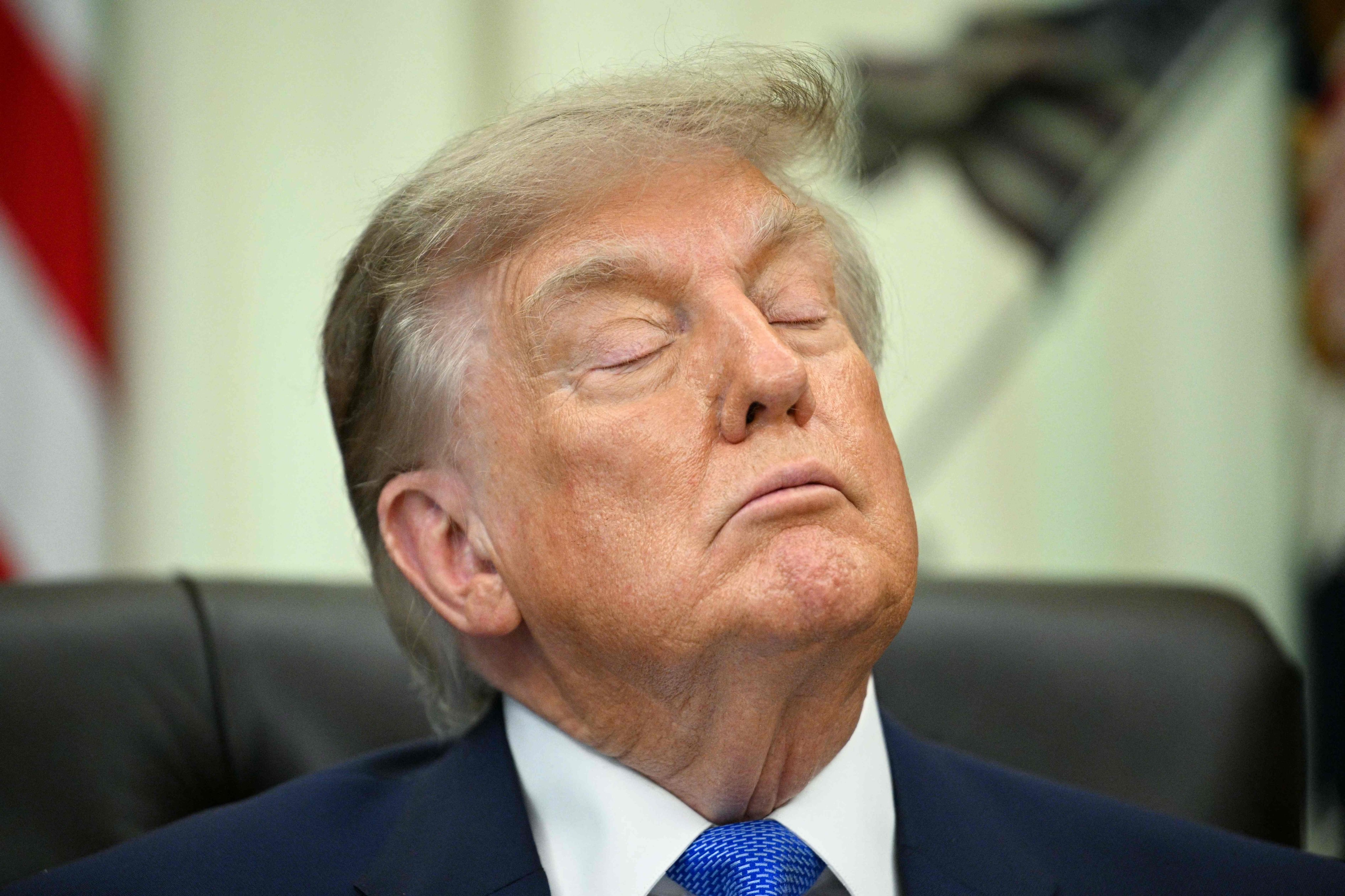 US President Donald Trump closes his eyes before signing an executive order in the Oval Office of the White House in Washington on August 10. Photo: AFP