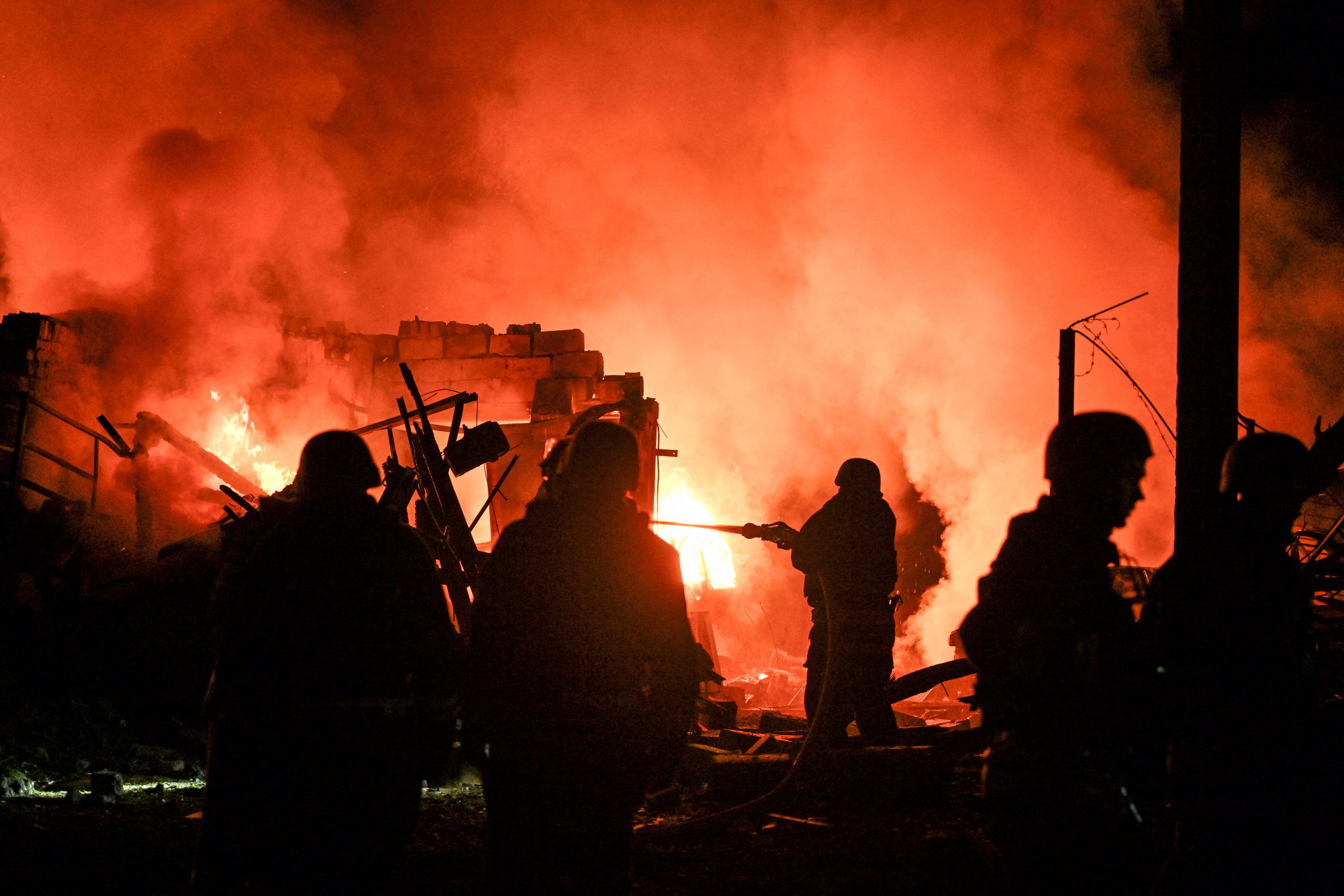 Firefighters work at the site of an overnight Russian missile strike in Zaporizhzhia, Ukraine on Tuesday. Photo: Reuters