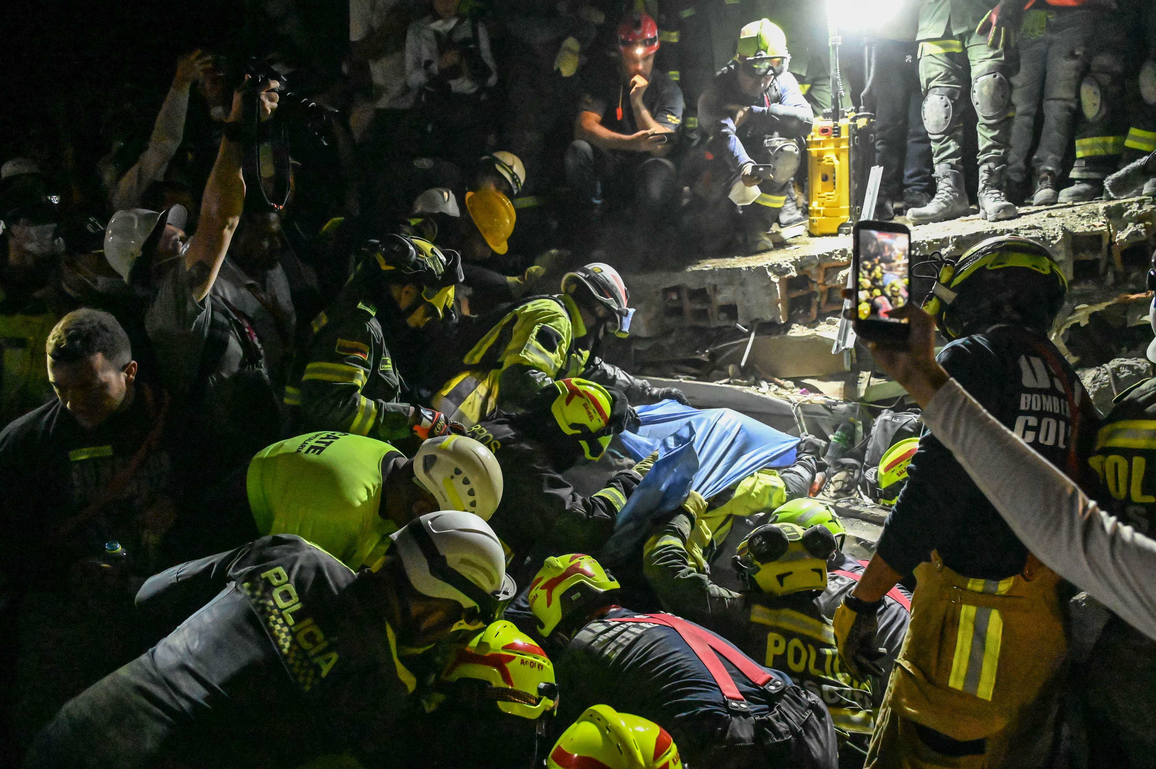 Firefighters and rescuers carry survivor Daniela Largo out of the rubble of a collapsed building after an earthquake in Cali, Colombia, on Tuesday. Photo: AFP