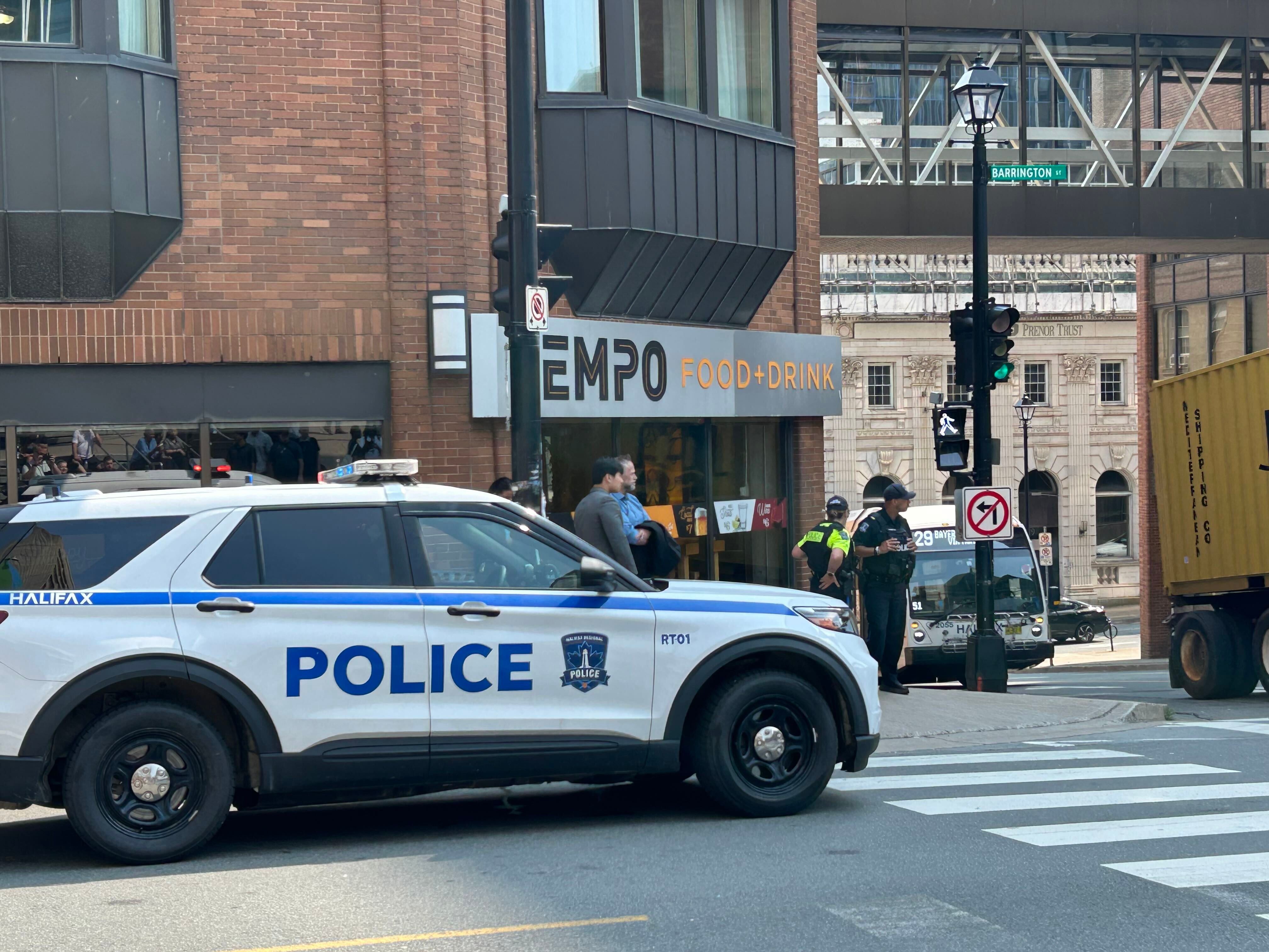 Police direct people asked to evacuate the US consulate in downtown Halifax, Canada on Monday. A suspect was charged with making a bomb threat on Tuesday. Photo: The Canadian Press via AP