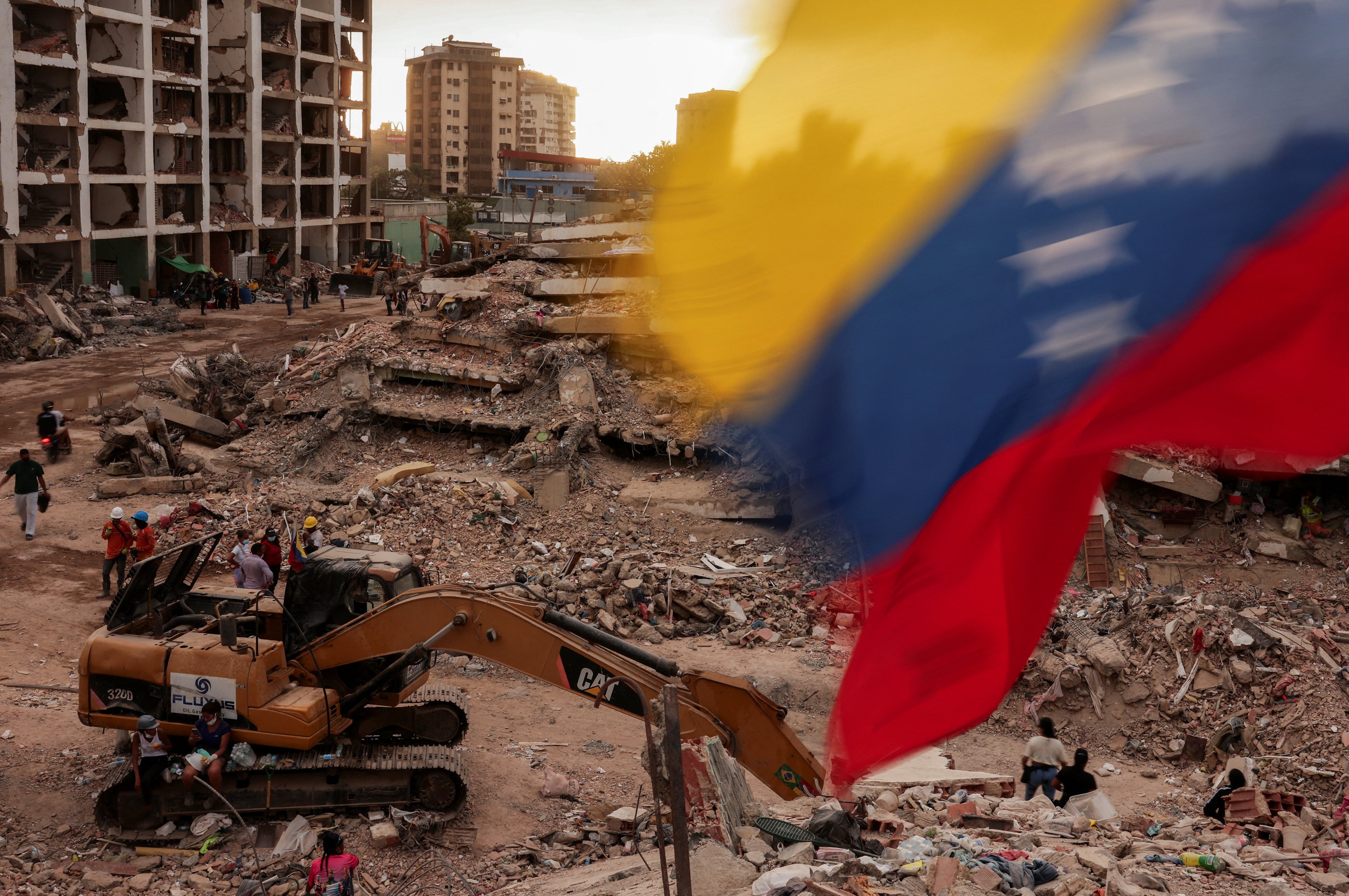 A Venezuelan flag waves as people search for bodies in Caraballeda, La Guaira, after earthquakes in June. Israel sent aid to Venezuela following the earthquakes. Photo: Reuters
