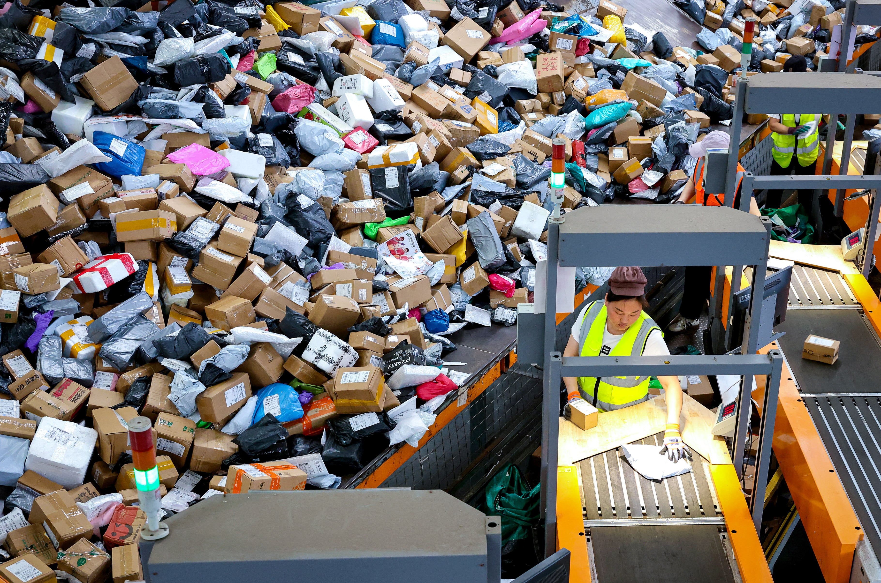 Staff members sort express parcels at the China Post Zaozhuang branch in Shandong province. Photo: Xinhua