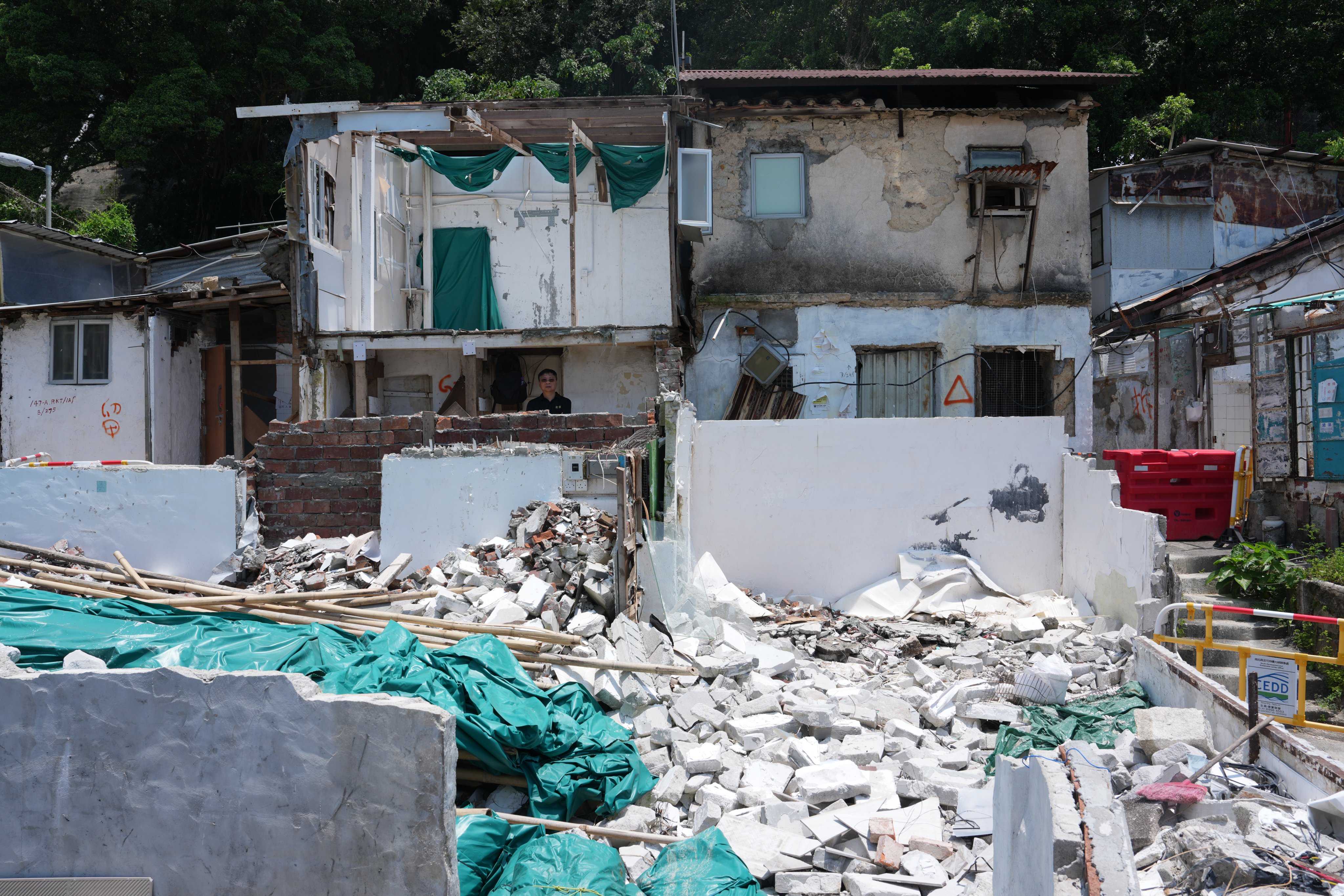 A security guard stands next to a cordoned-off area in the village. Photo: Sam Tsang