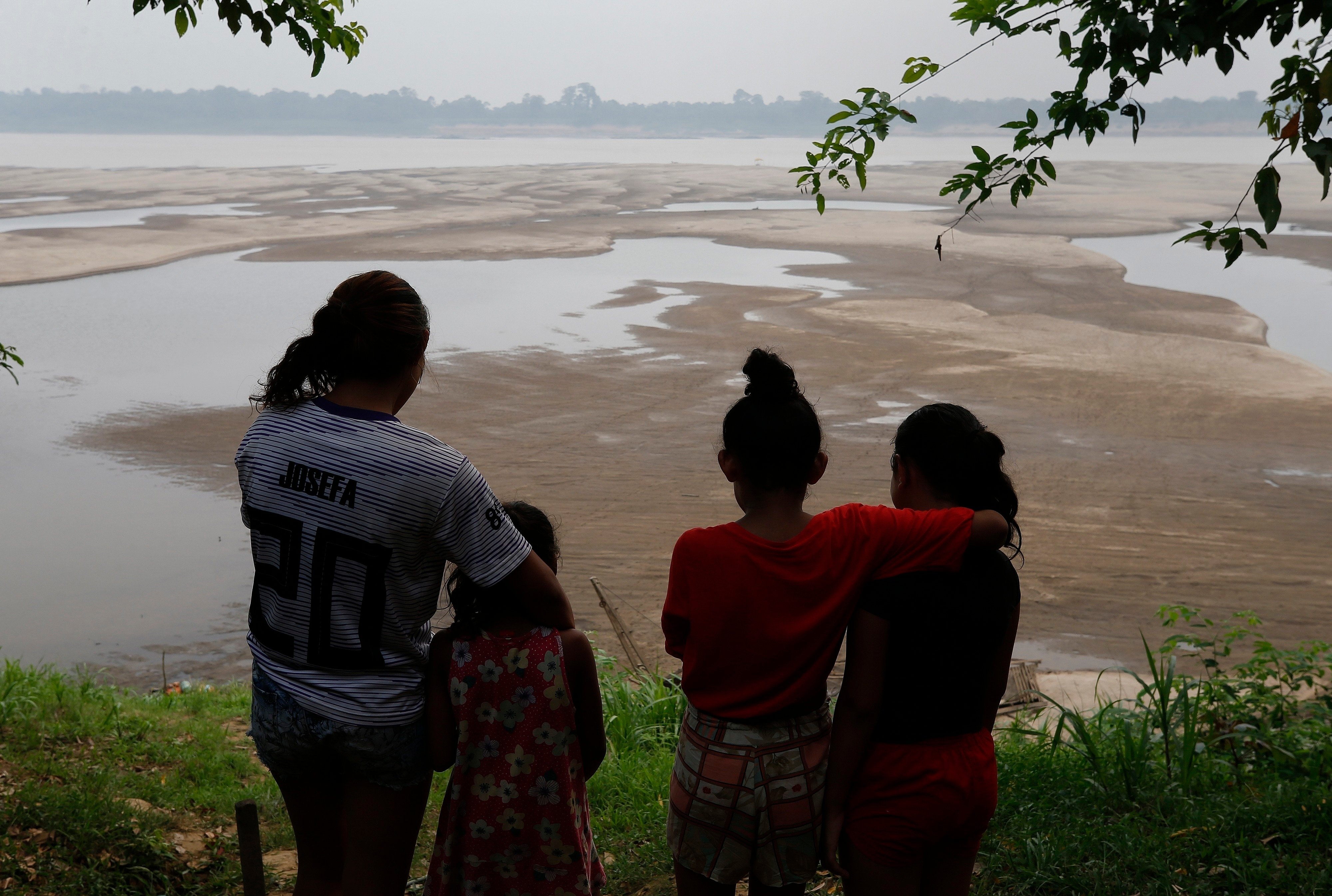 Residents look out at the Madeira River, a tributary of the Amazon River amid a drought in Humaita, Amazonas state. Brazil has teamed up with China to create a geostationary satellite that can predict extreme weather events. Photo: AP