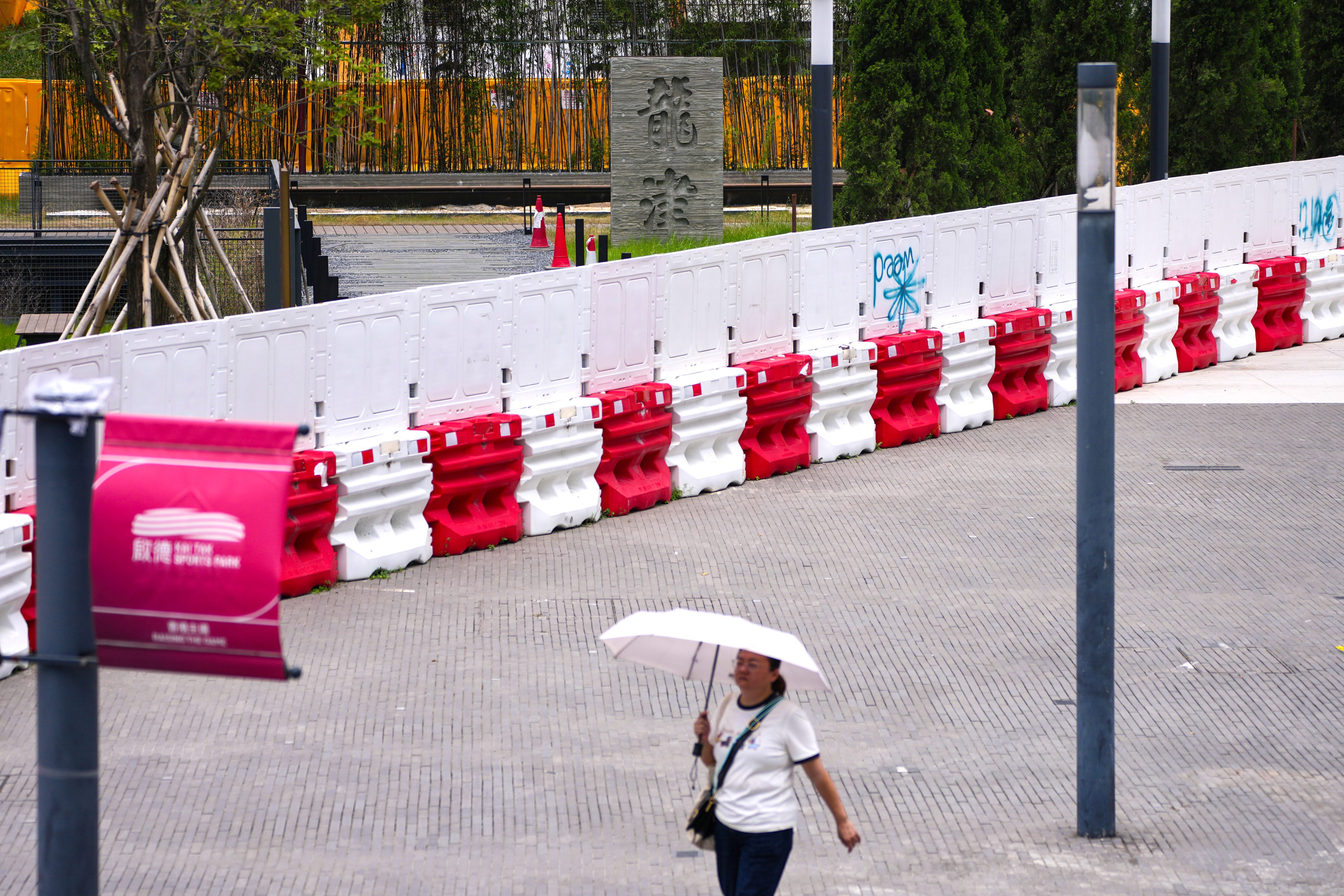 A woman walks through the Kai Tak neighbourhood on August 11. Photo: Karma Lo