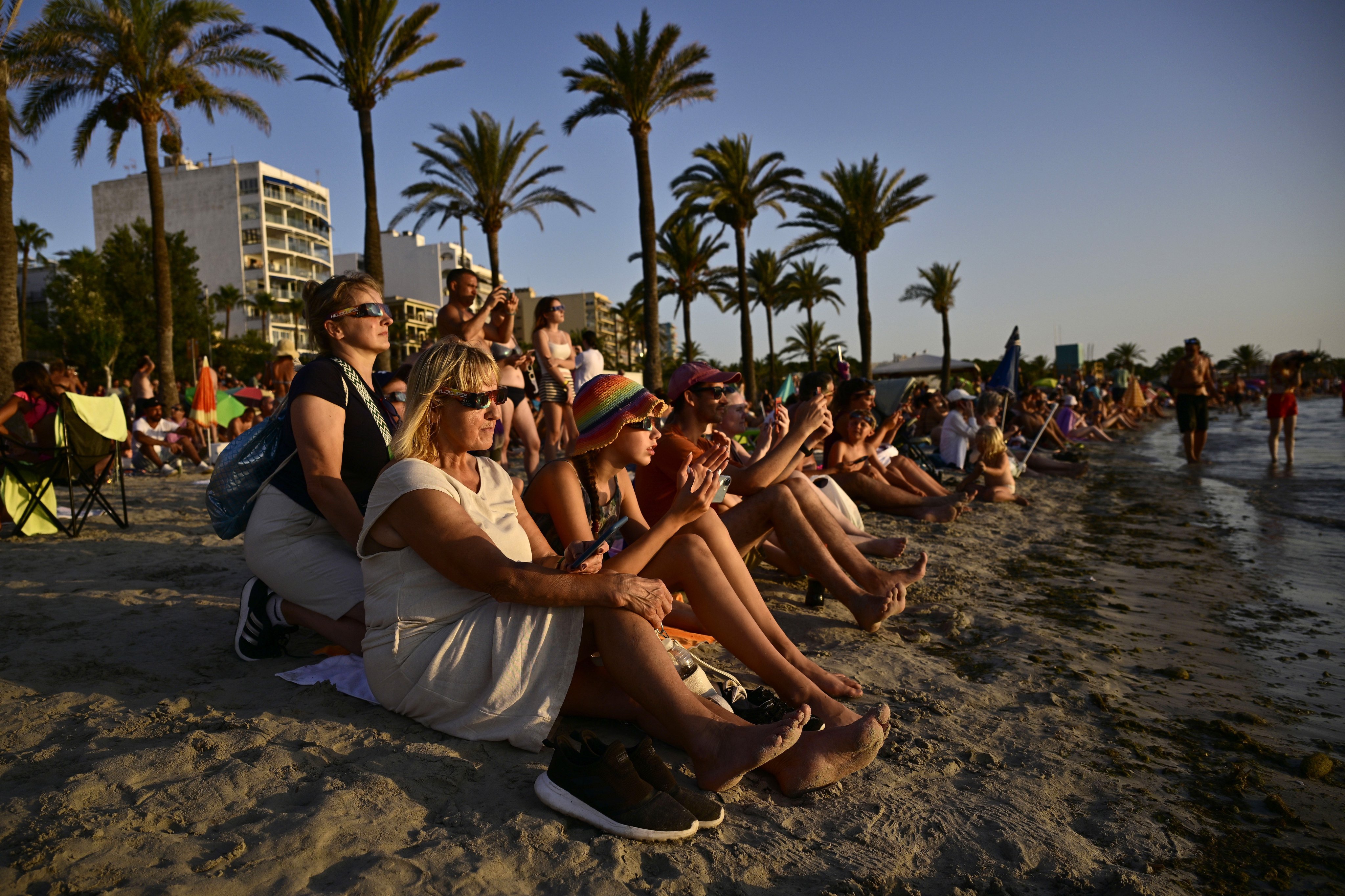 People watch the solar eclipse from El Arenal, south of Palma, in Spain’s Balearic Islands, on Wednesday. Photo: EPA