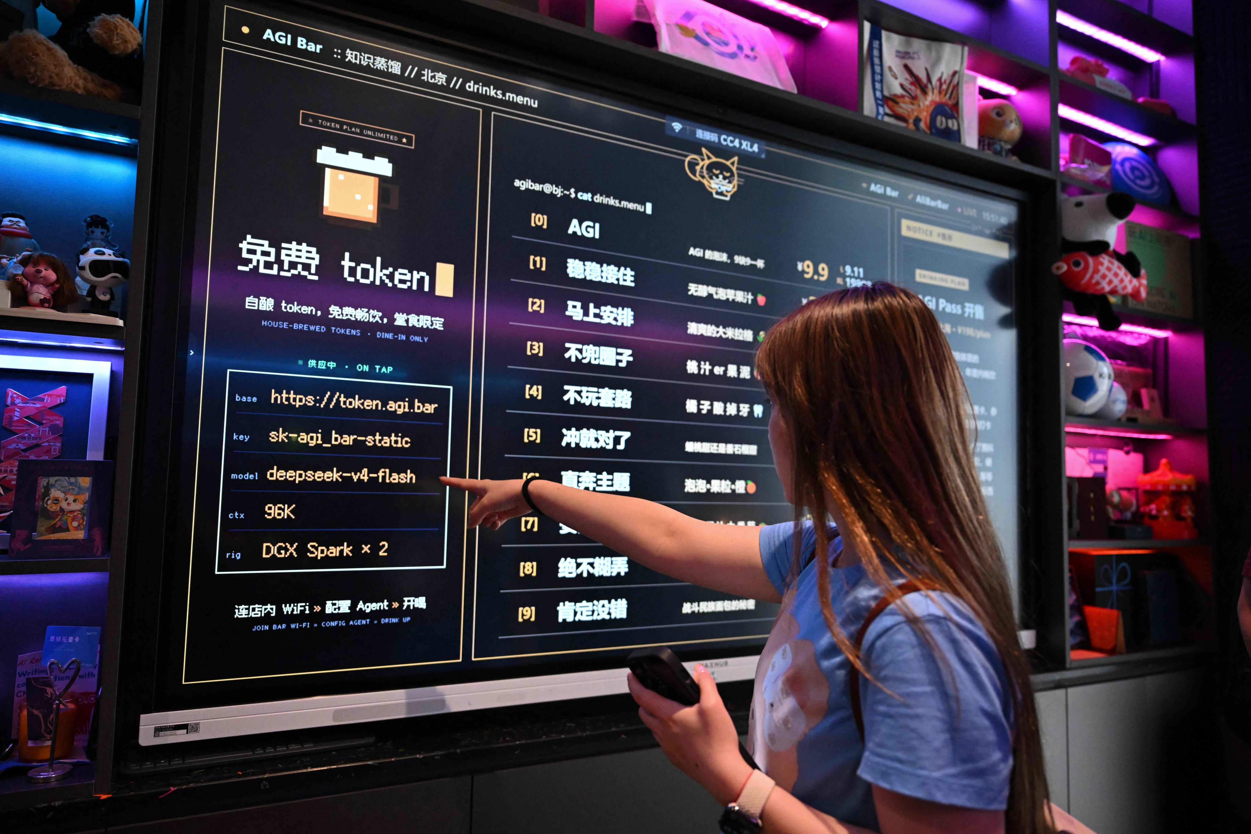 A customer looks at a board with the menu at AGI Bar in Beijing’s Zhongguancun district on August 9. AI users are shopping around as US giants face fierce competition from Chinese rivals -- and in Beijing’s tech district, customers at an AI-themed bar can even plug into DeepSeek for free. Photo: AFP
