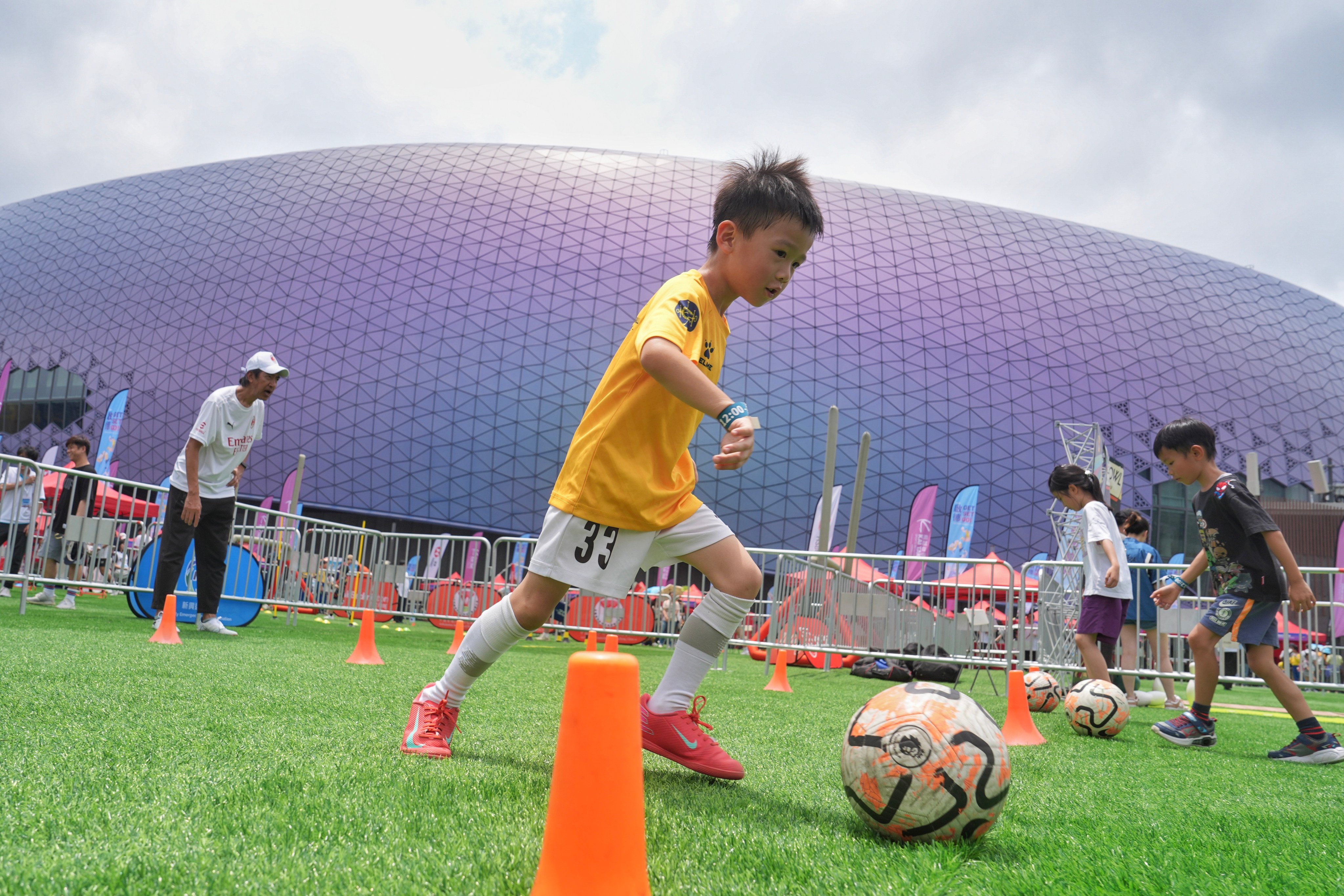 Some children take part in a football drill at Kai Tak Sports Park. Photo: Elson Li