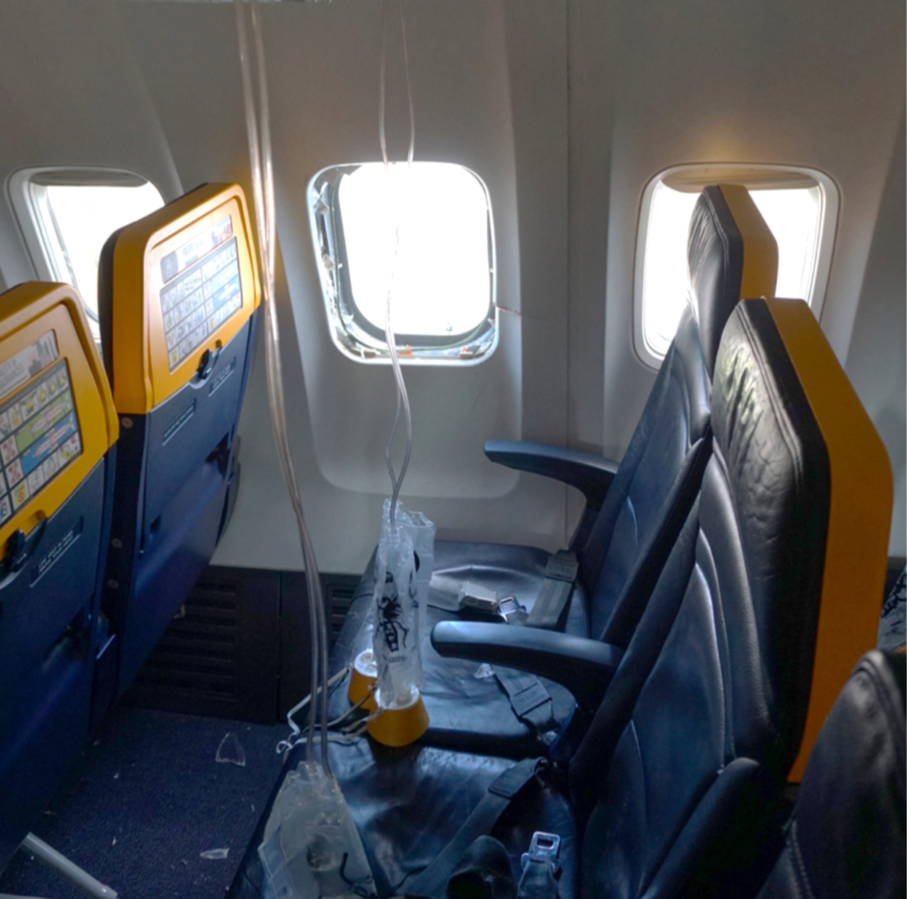 An undated image shows the window on a Ryanair plane that was broken by a stray engine part shortly after take-off, causing a man’s head to be sucked into the hole. Photo: National Transportation Safety Board via AP
