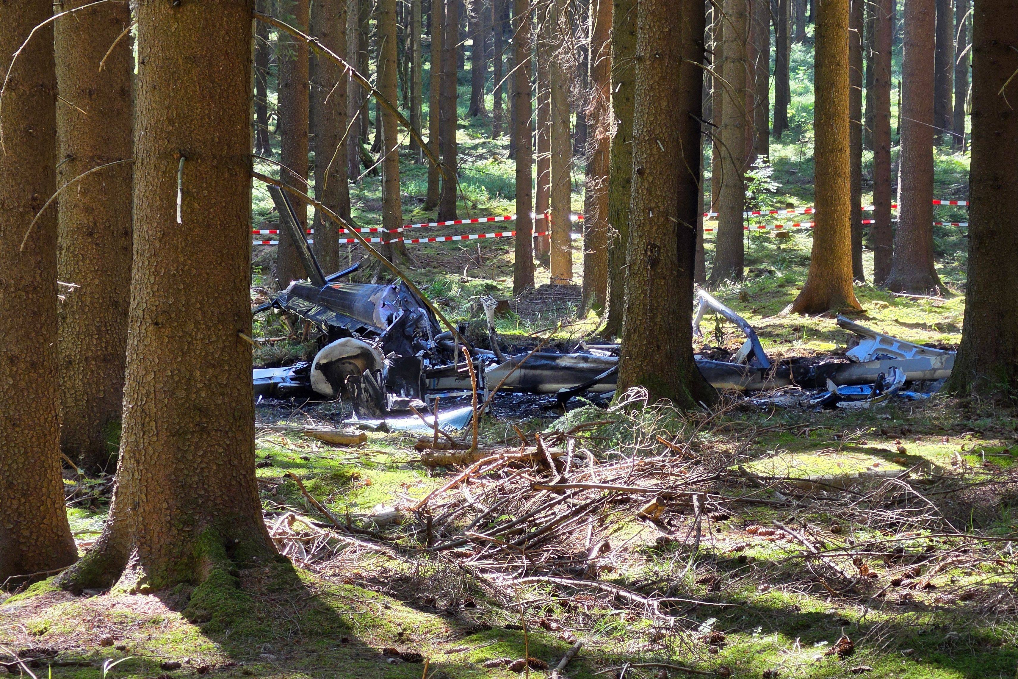 The wreckage of a helicopter lies in a wooded area in Germany’s Ore Mountains while doing liming work on Friday. Photo: dpa