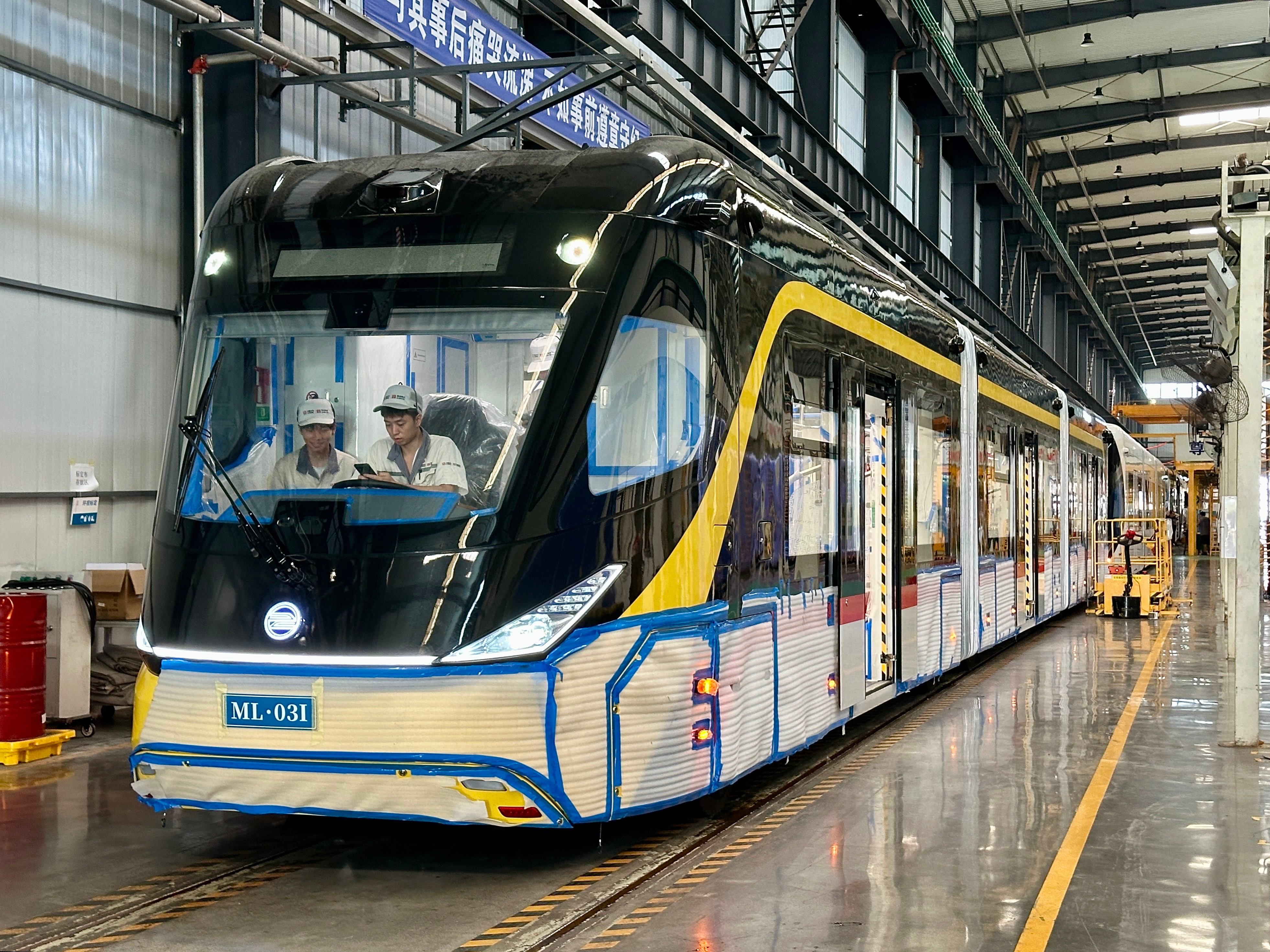 Workers are seen inside a carriage of an autonomous rapid transit vehicle at a CRRC plant in Yibin, southwest China’s Sichuan province. When construction is complete, the bus will be shipped to Kuching, Malaysia. Photo: Frank Chen