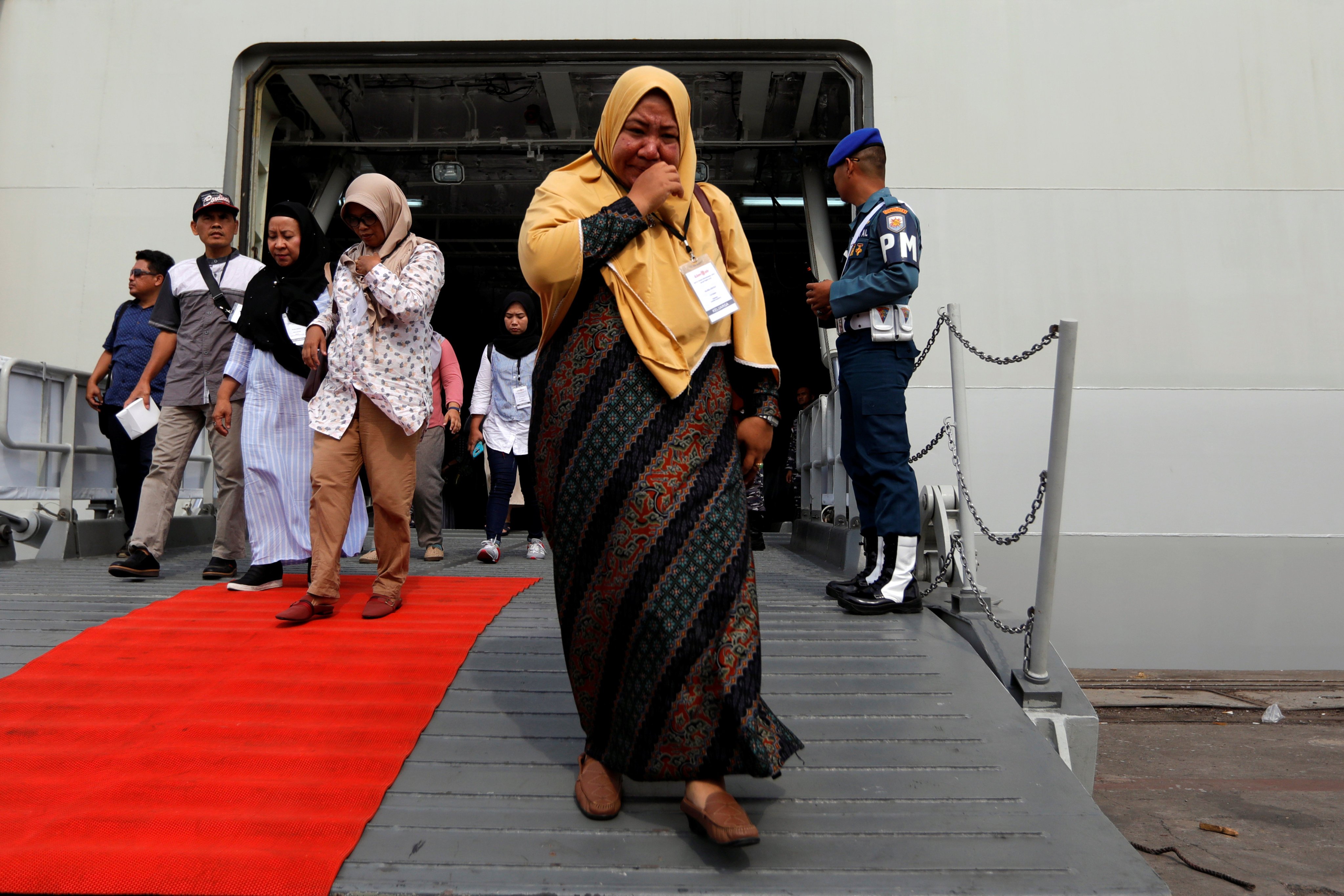 A relative of a passenger who died on Lion Air JT-610 crash at the Java Sea cries as she arrives at Jakarta International Port after attending the one-year commemoration of the crash in Jakarta in 2019. Photo: Reuters