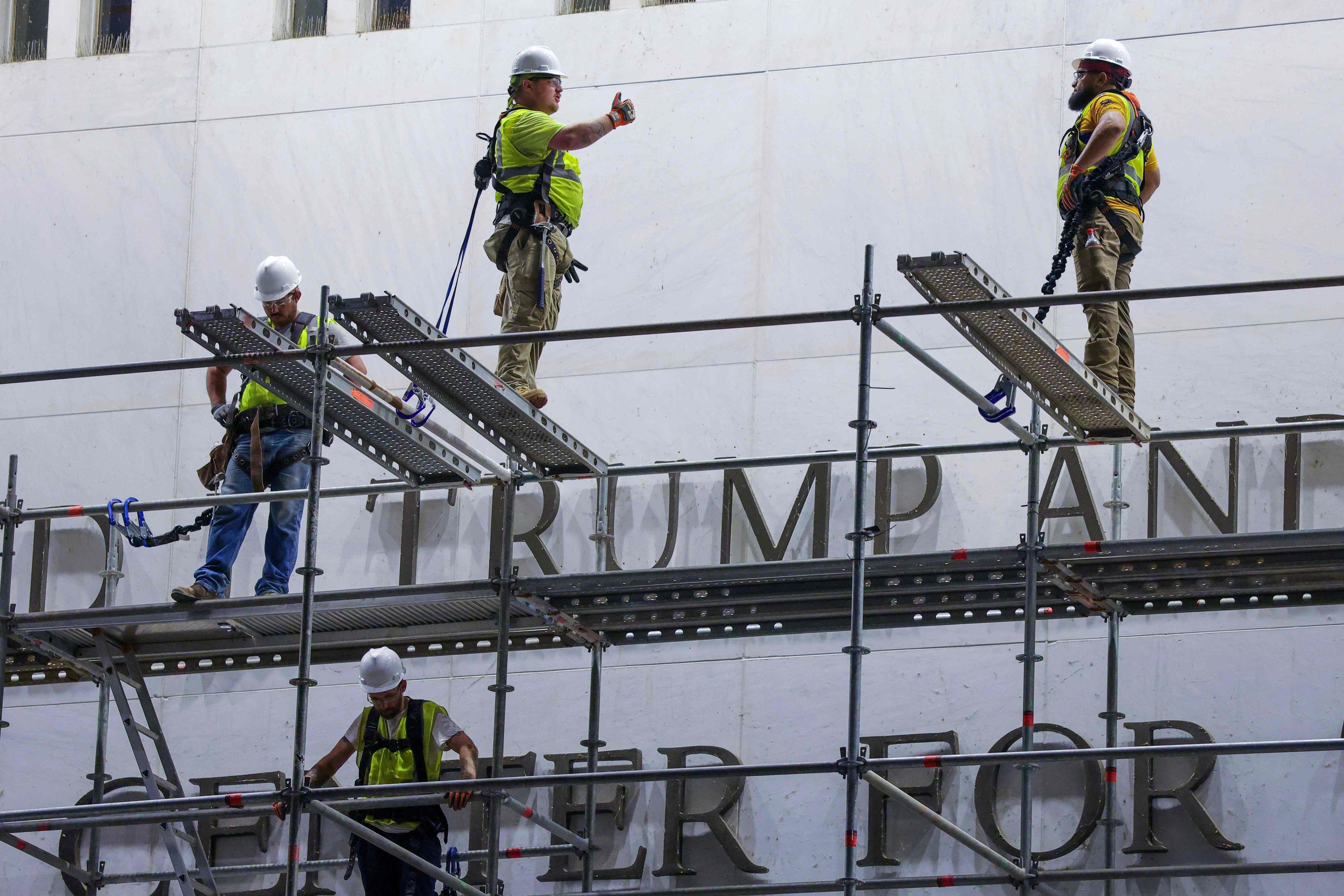 Construction crews build scaffolding outside The Kennedy Centre in June, after a court ordered that Trump’s name be removed from the building. Photo: AFP
