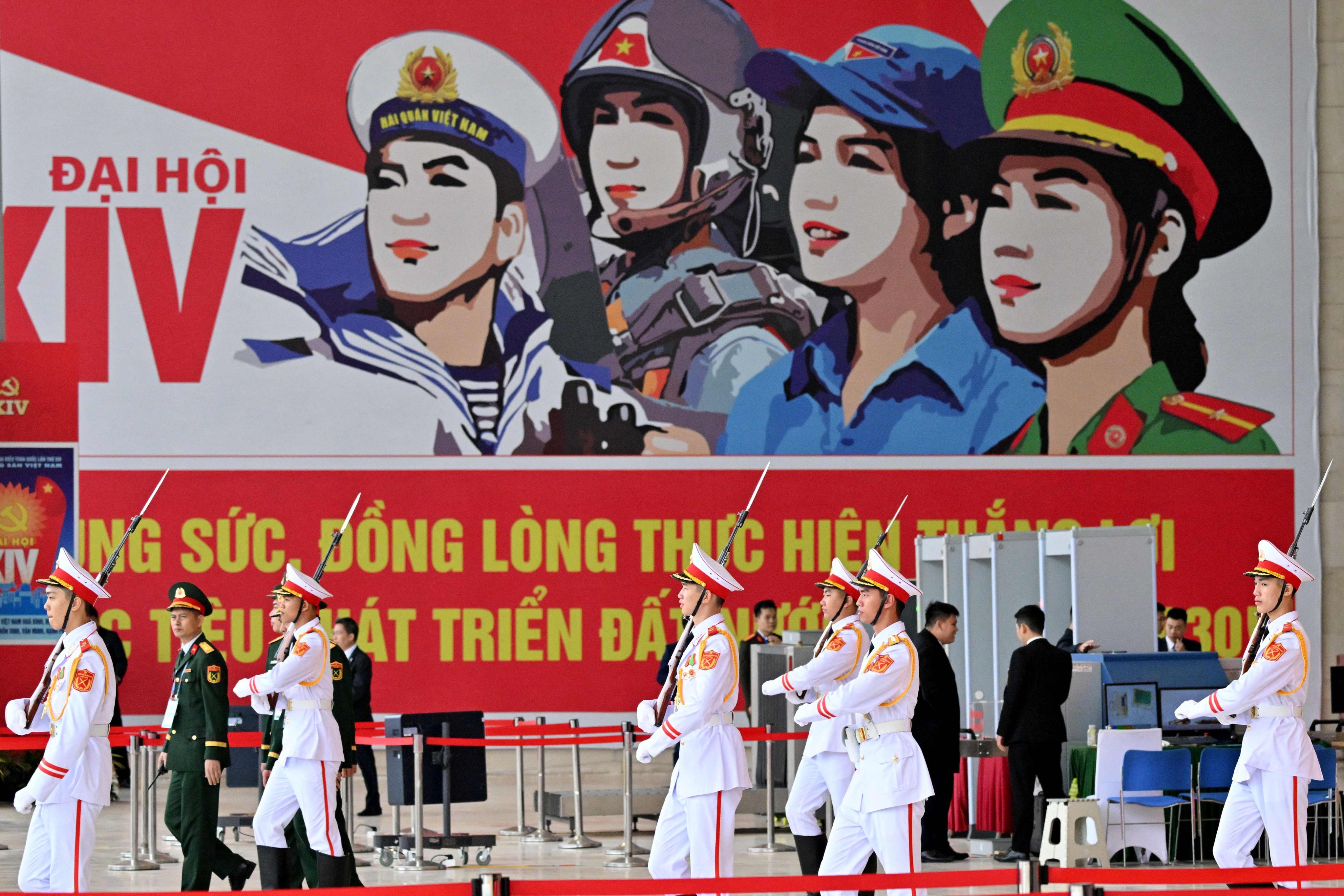 Honour guards walk past a billboard advertising the 14th National Congress of the Communist Party of Vietnam in Hanoi in January. Photo: AFP