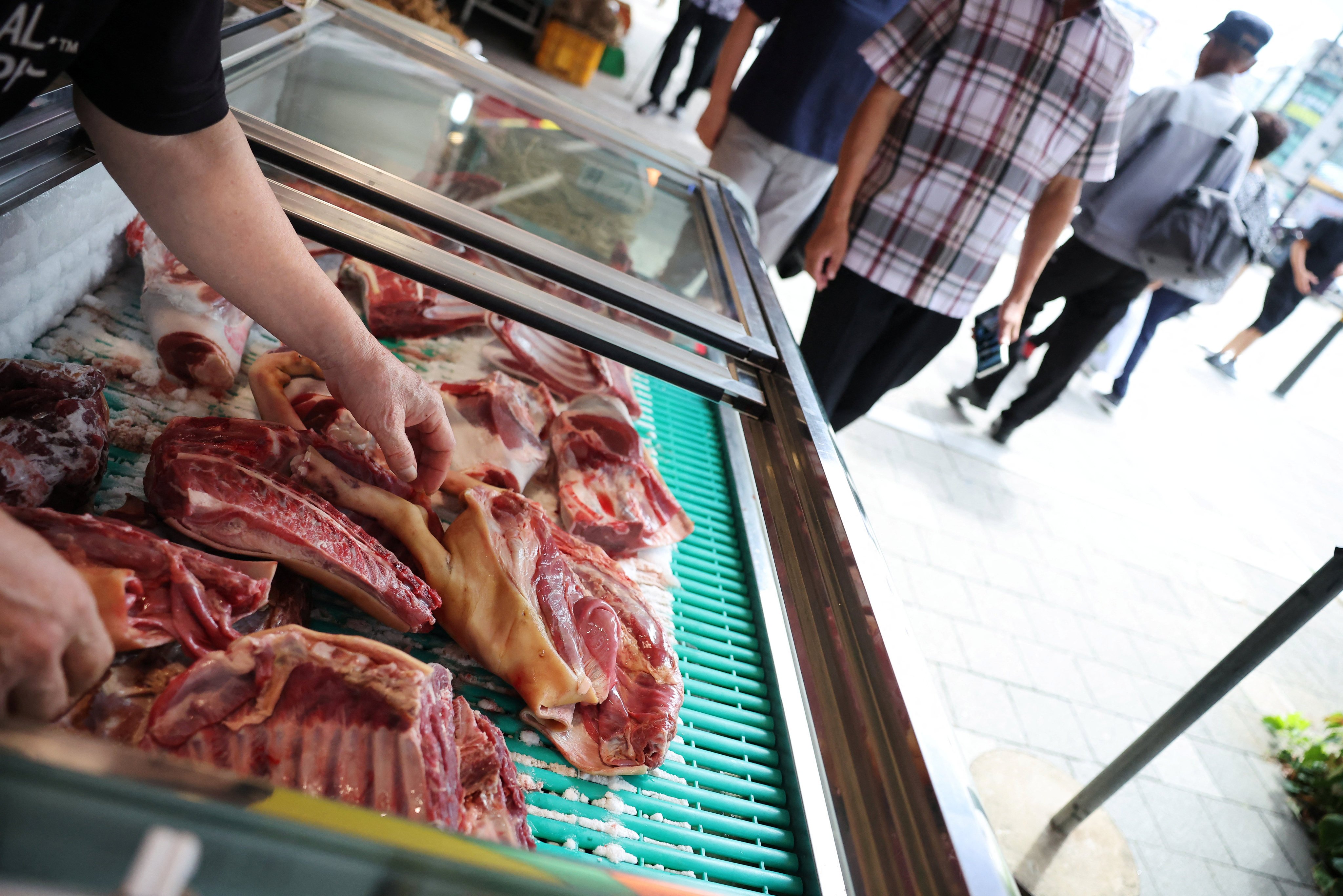 An employee displays chopped dog meat for sale in Seongnam, South Korea on Friday. Photo: Reuters
