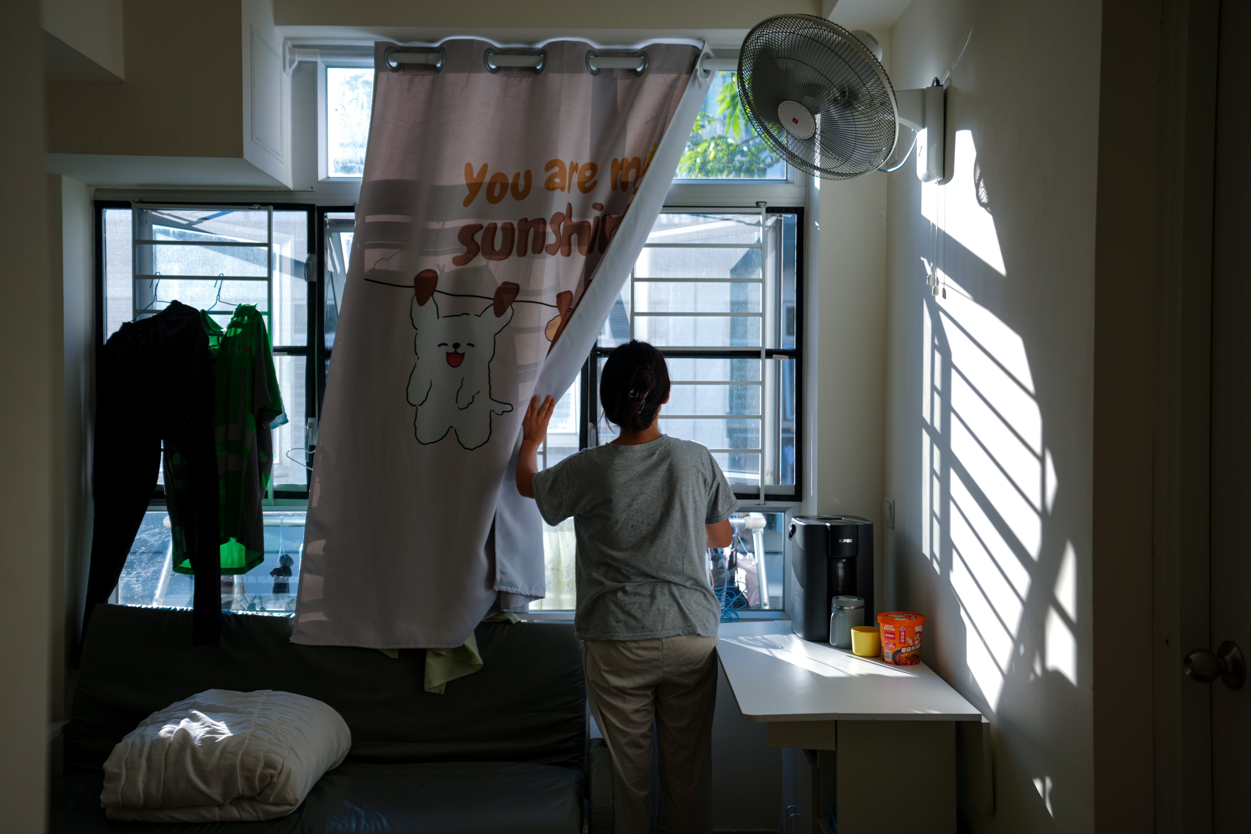 Zeng Meishi, 32, in her 200 sq ft transitional housing flat in Cheung Sha Wan. Photo: Sam Tsang