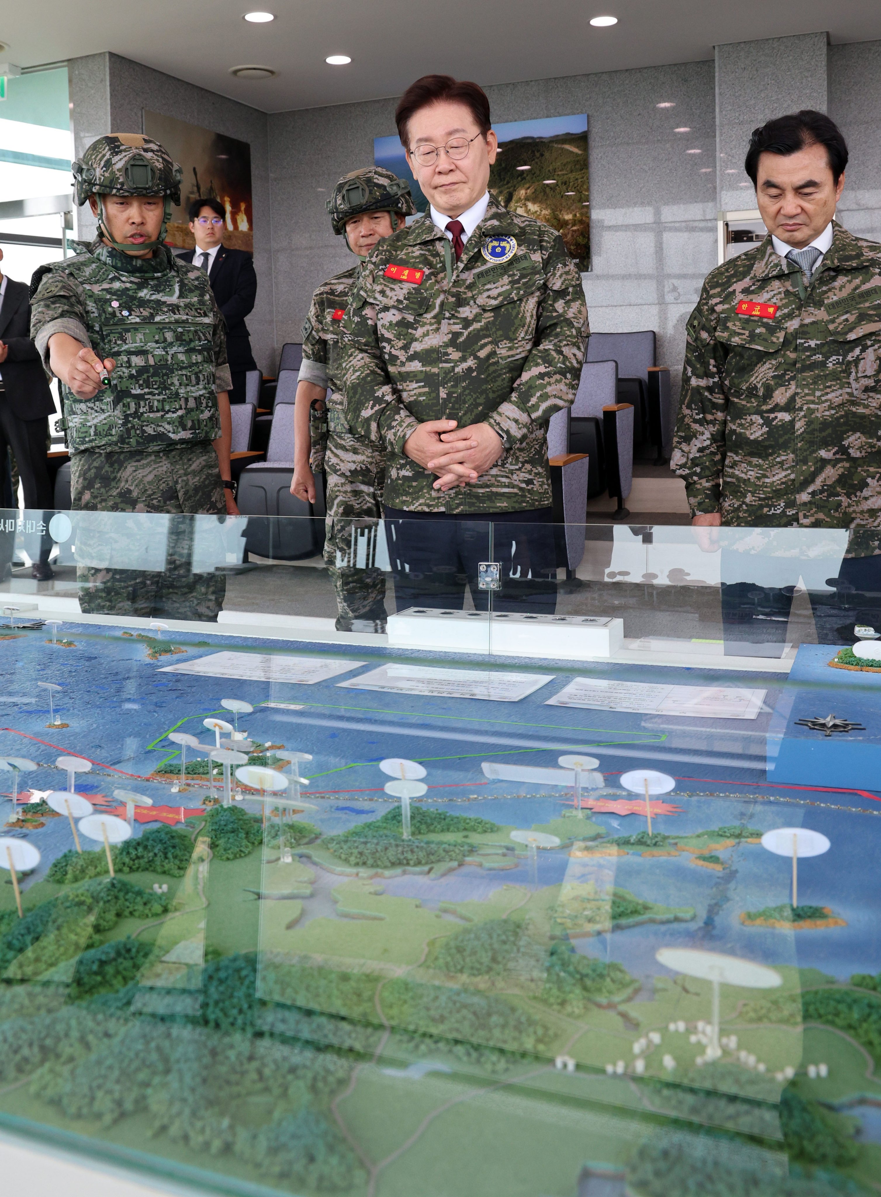 South Korean President Lee Jae Myung (centre) and Defence Minister Ahn Gyu-back (right) listen to a military officer at an observatory on Yeonpyeong Island in South Korea in June. Photo: EPA