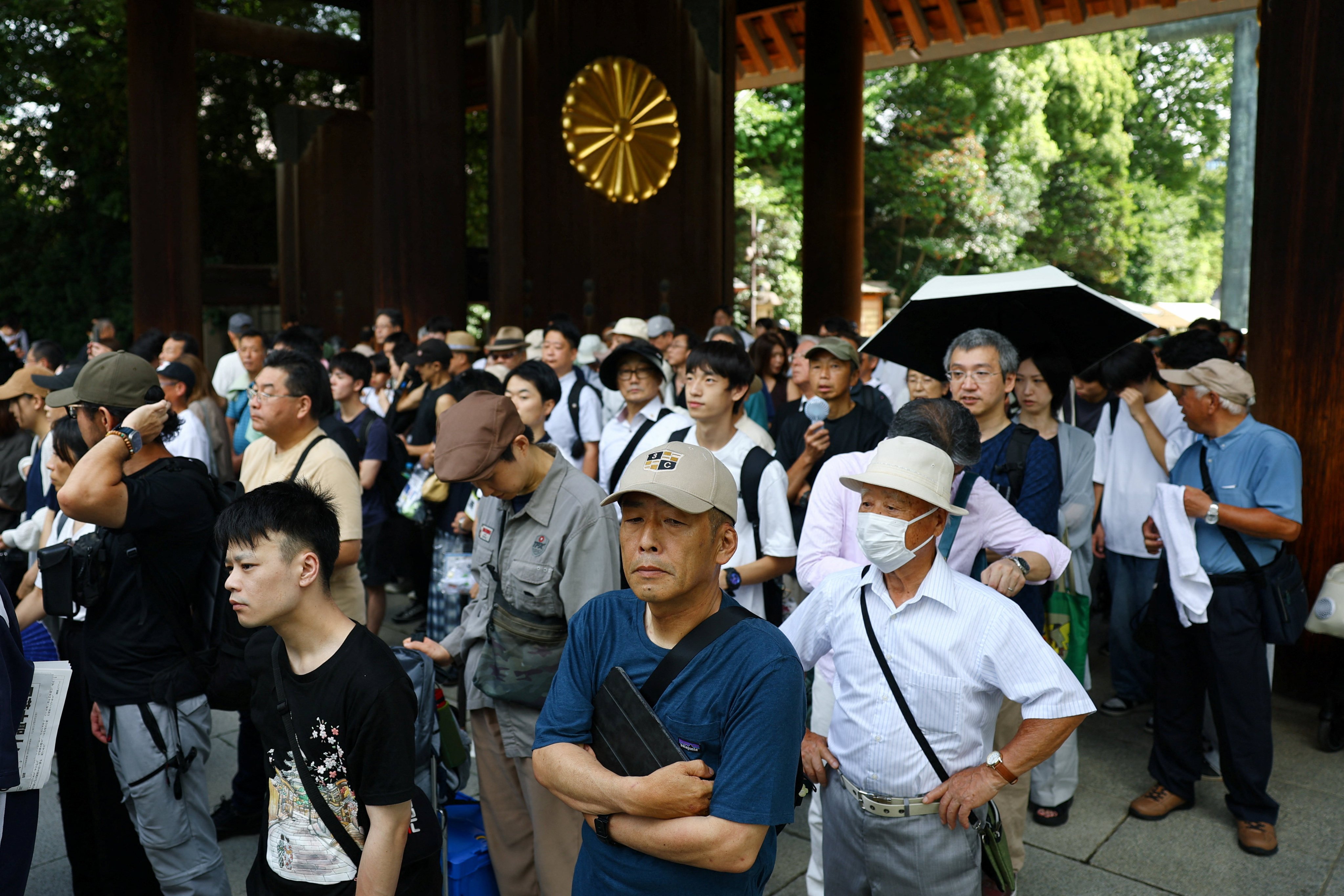 People visit to pay tribute to the war dead at Yasukuni Shrine in Tokyo on Saturday on the 81st anniversary of Japan’s surrender in World War II. Photo: Reuters