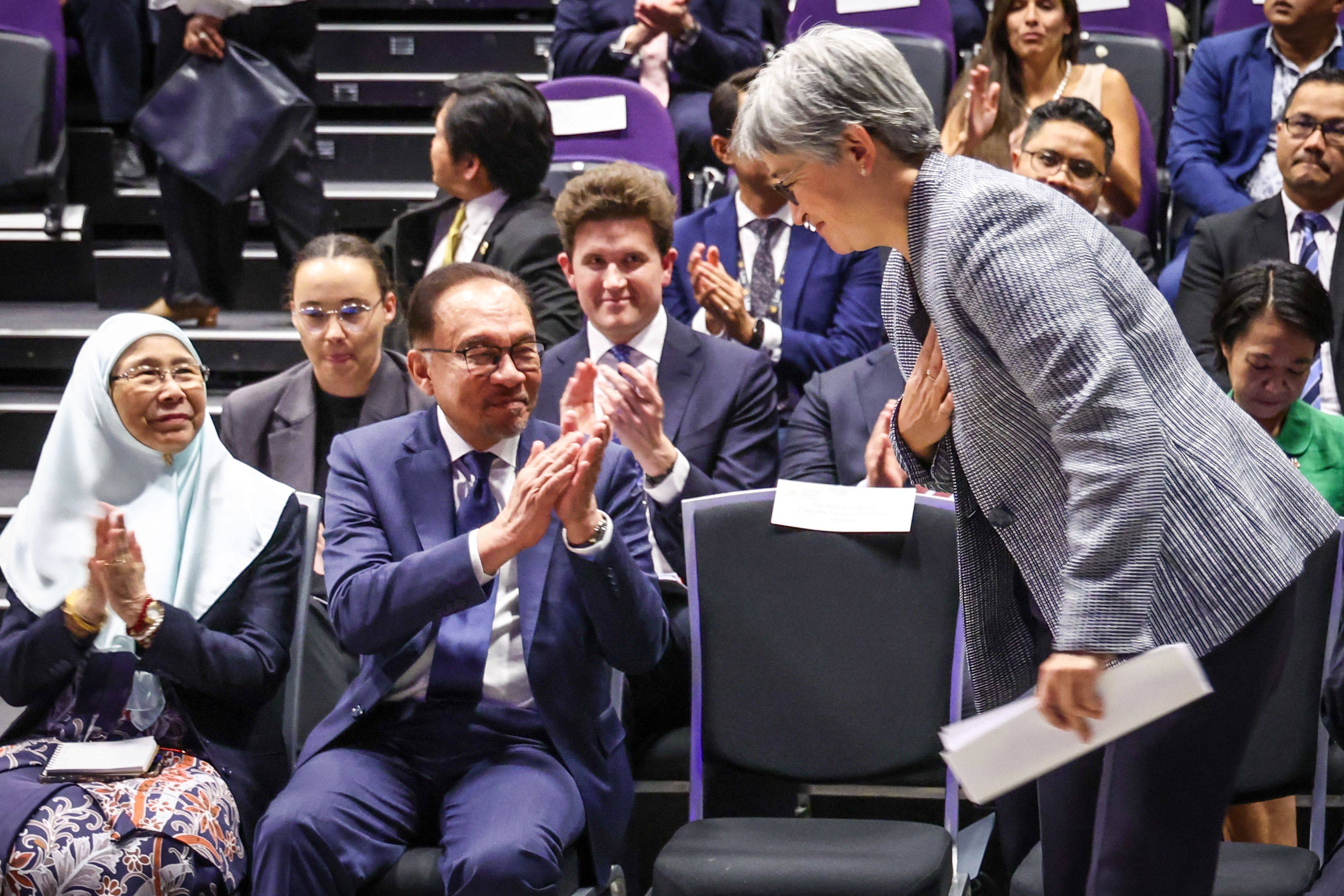 Malaysia’s Prime Minister Anwar Ibrahim (centre) and his wife Wan Azizah Ismail (left) react as Australian Foreign Minister Penny Wong (right) gets up to speak during an event at Australian National University (ANU) in Canberra on March 7, 2024. Photo: AFP