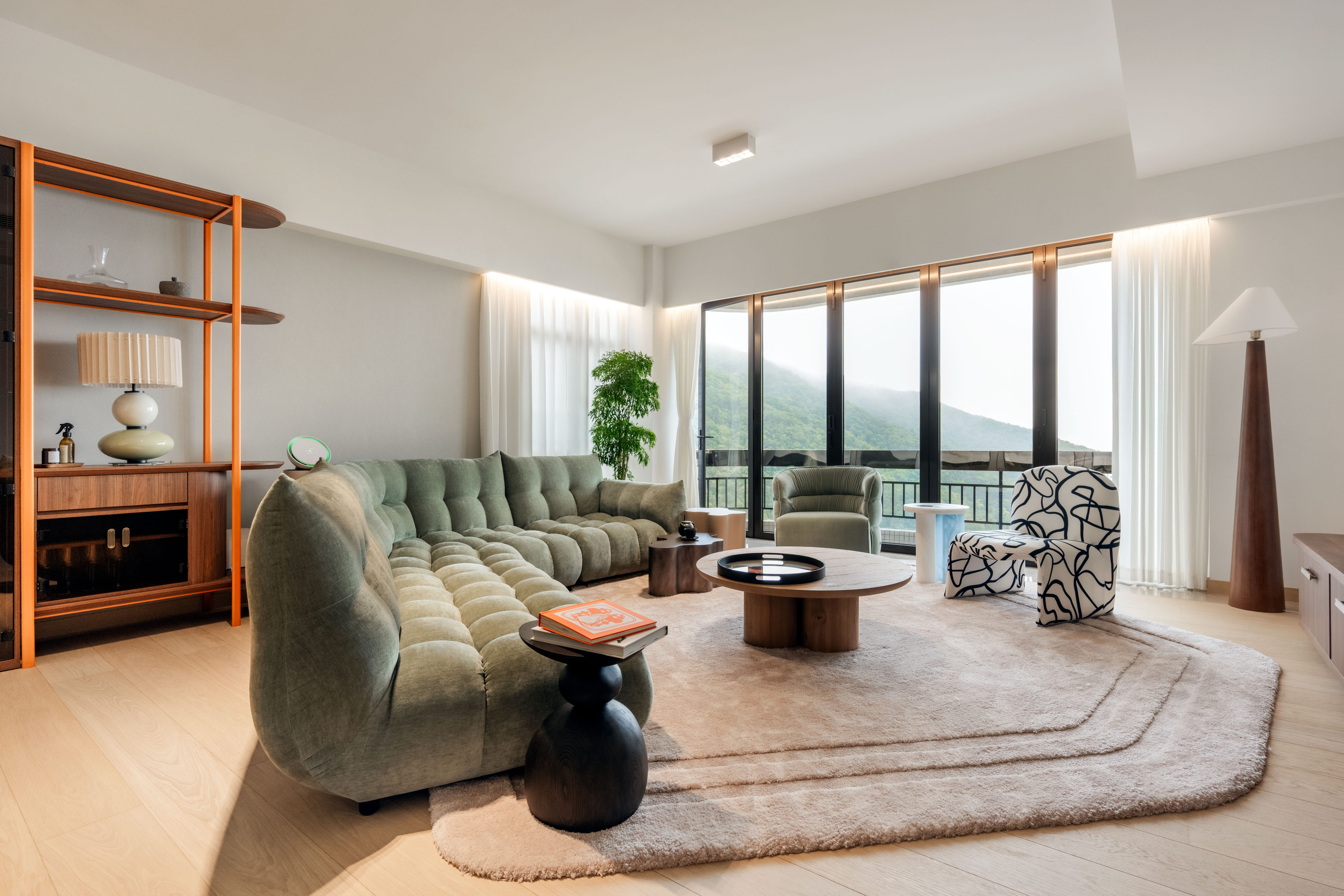 The large living area of this Repulse Bay apartment was sectioned into two zones: one anchored by the sofa for convivial relaxation, the other for dining, connected by a custom-made shelving unit running the length of the side wall. Photo: Eugene Chan