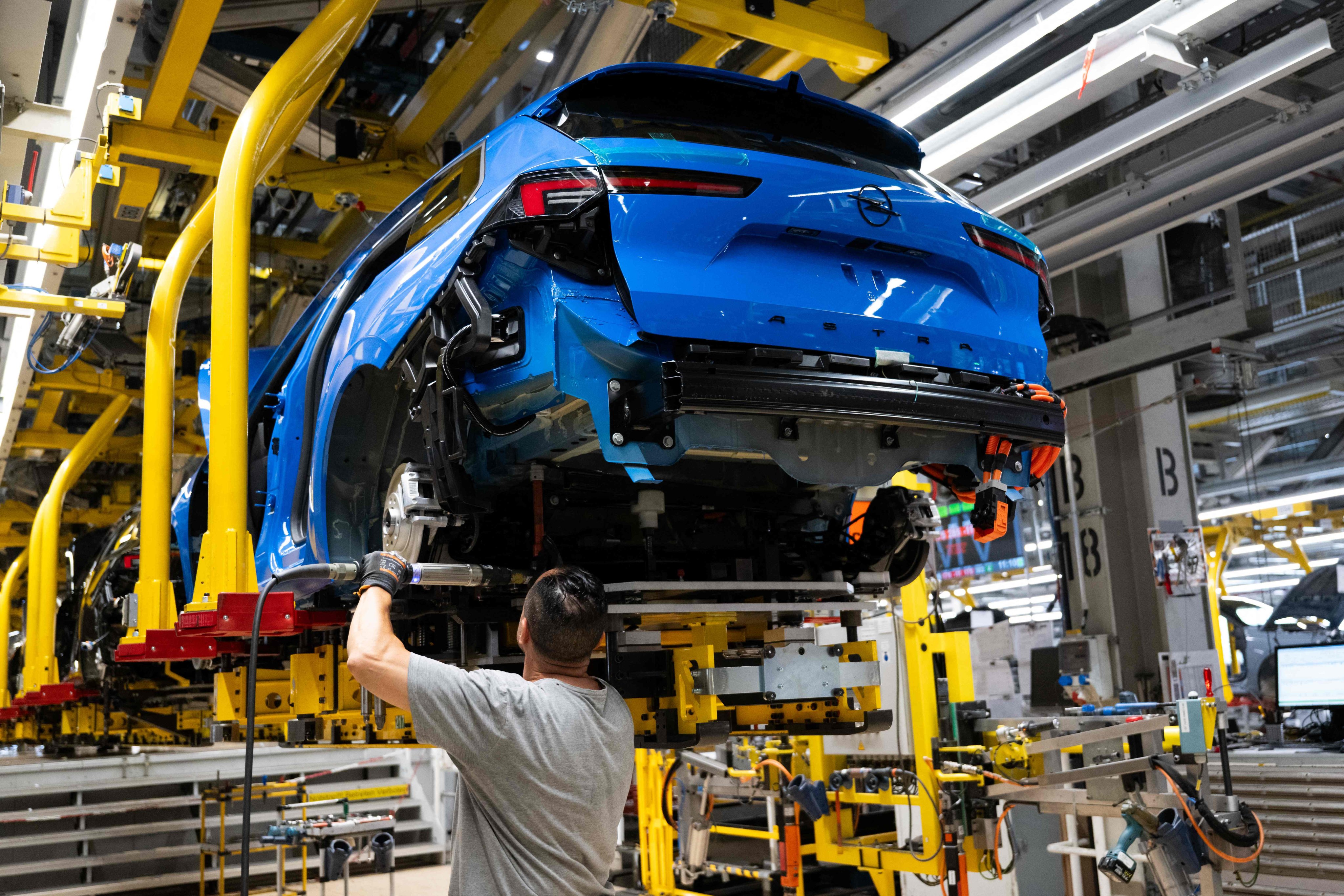 An Opel employee works on its Astra passenger car assembly line in Ruesselsheim, Germany, in June. Photo: AFP