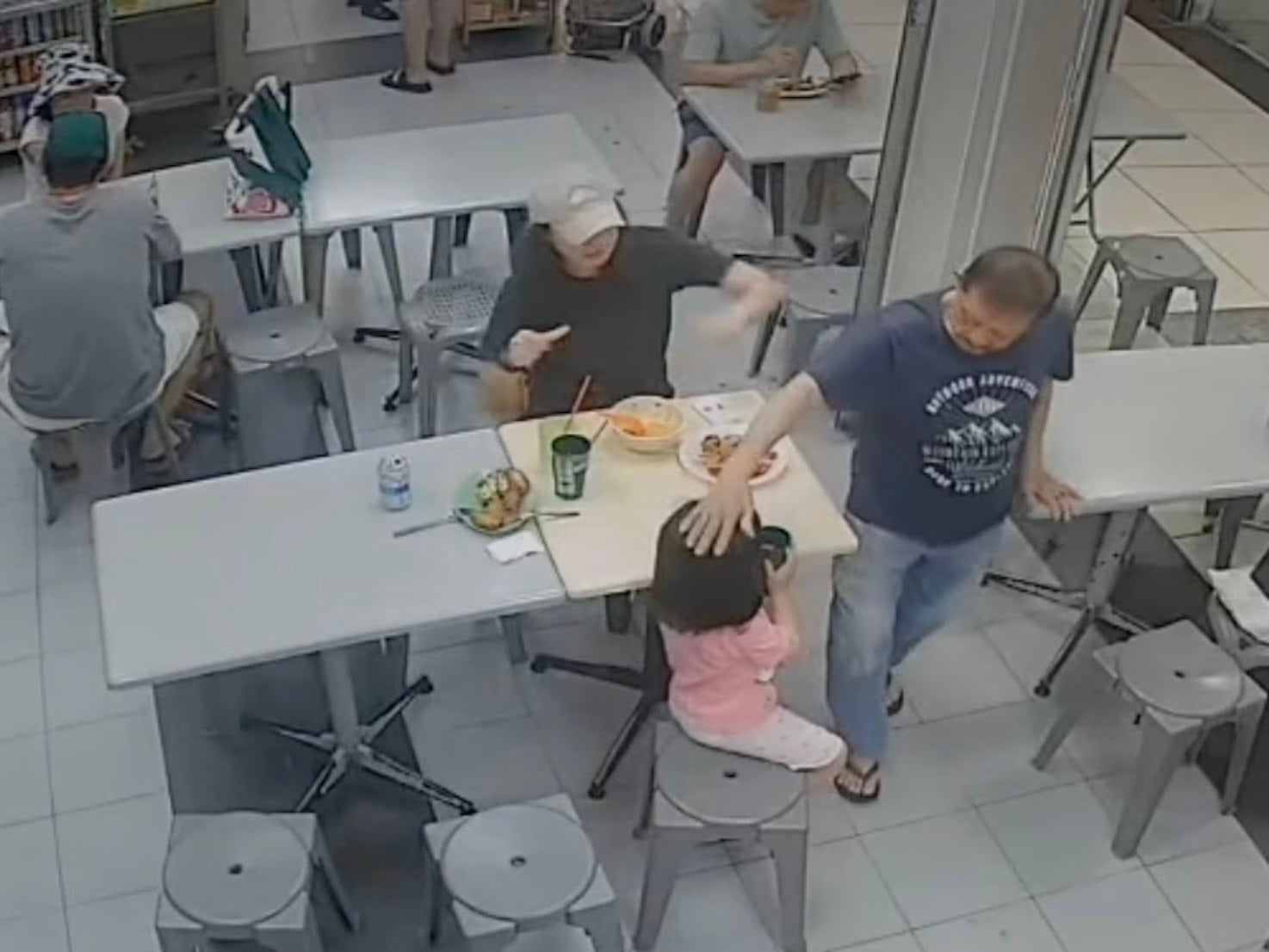 A 73-year-old man, Yeo Song Khoon, is seen patting a girl’s head at a food court in Roxy Square in Singapore on Saturday. Photo: Instagram/being1ton