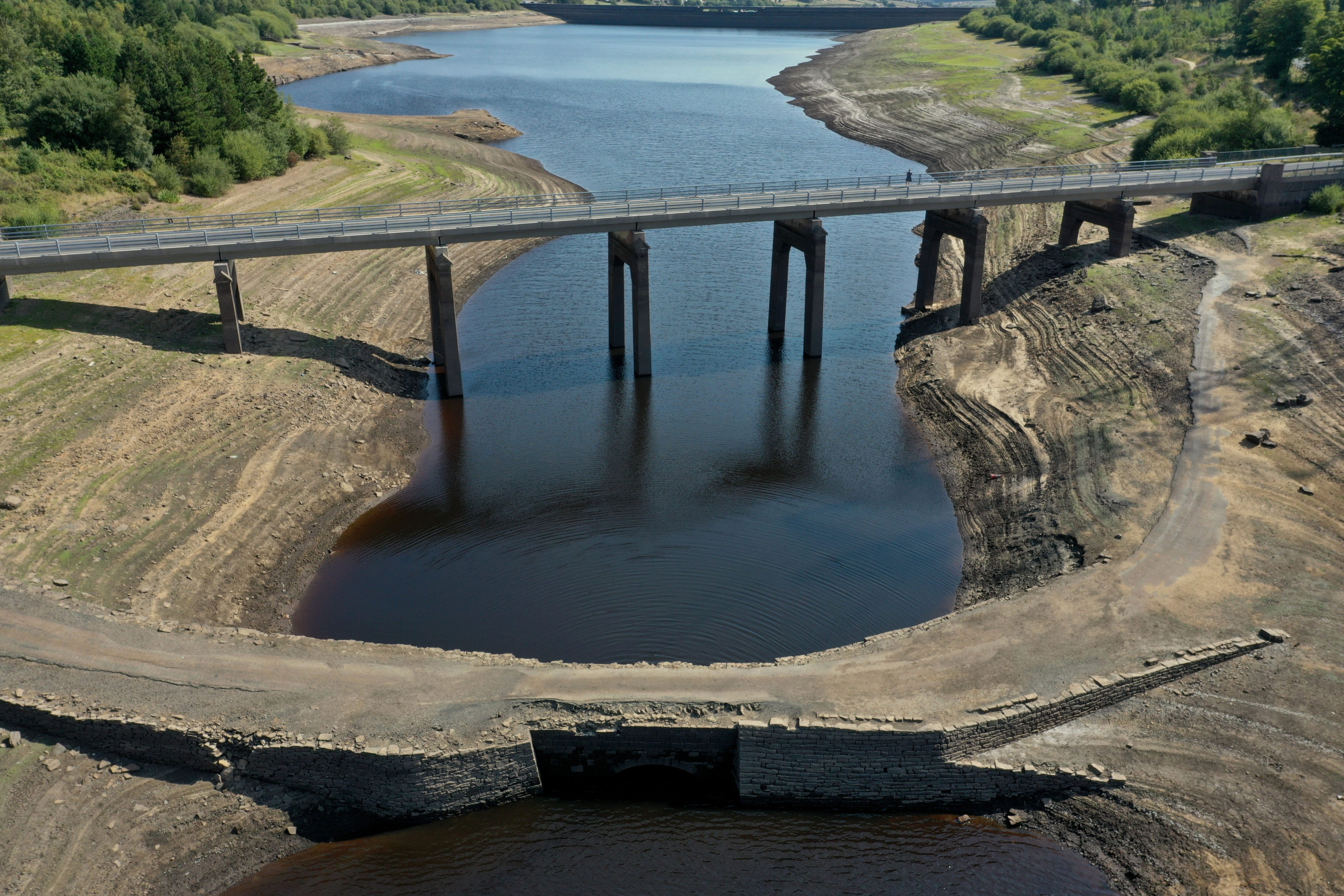 The historic packhorse bridge at Baitings Reservoir near Sowerby Bridge is exposed on Thursday as water levels drop throughout the country. Photo: AP