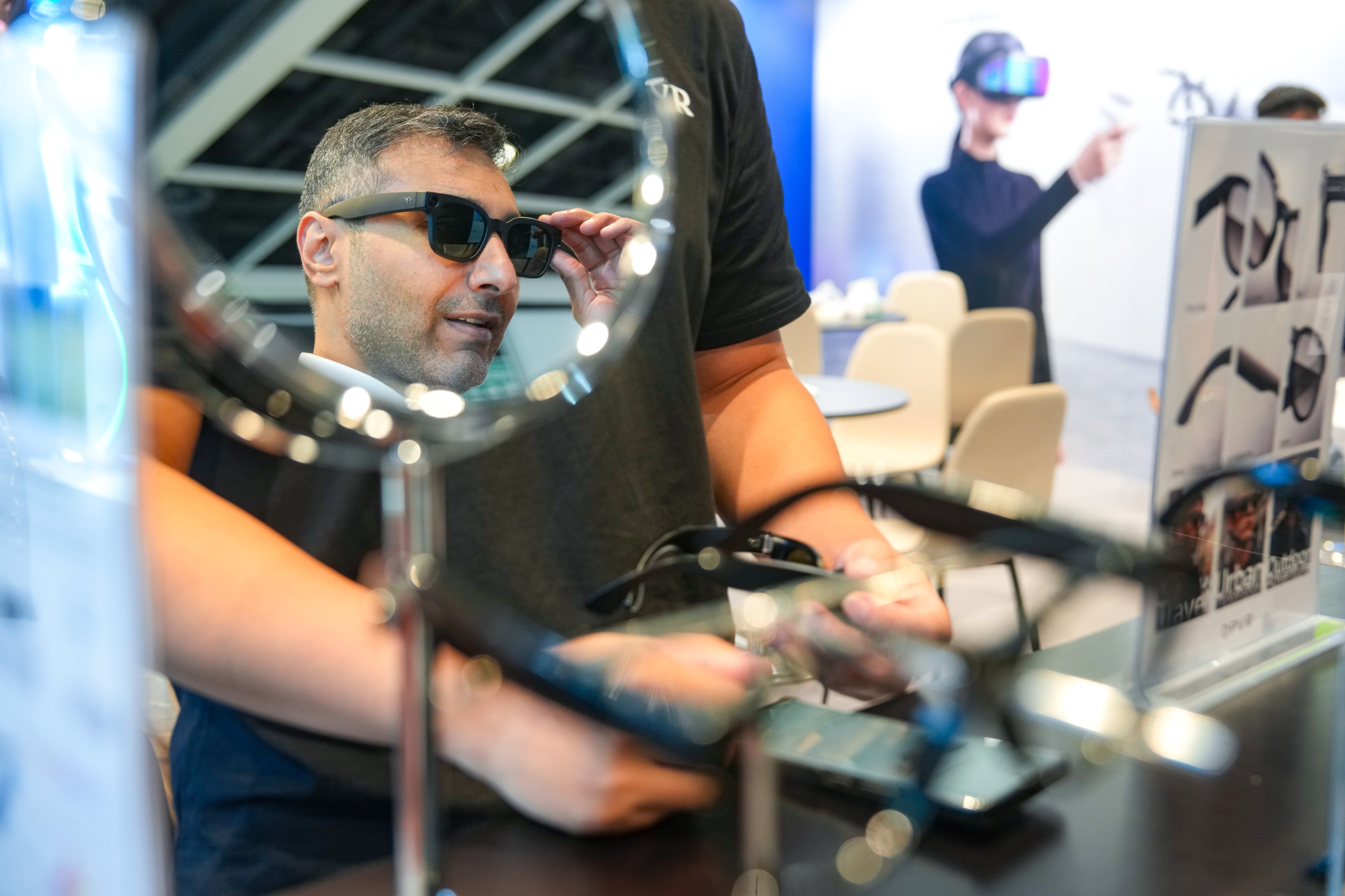Visitors try AI glasses at technology exhibition LEAP East. Photo: Sam Tsang