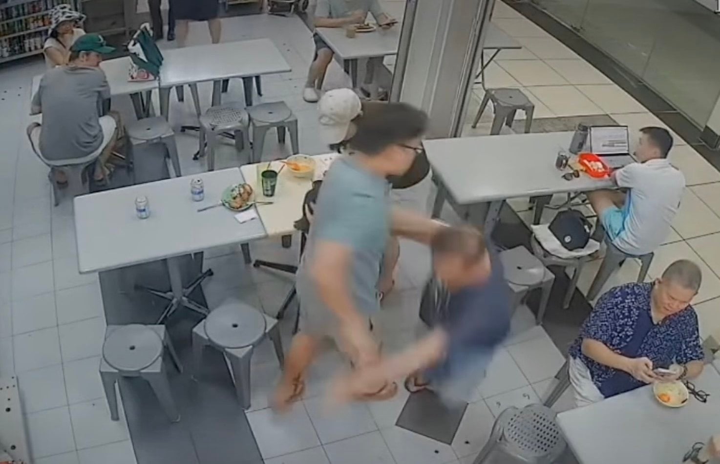 A man is seen shoving Yeo Song Khoon, 73, to the floor at a food court in Roxy Square in Singapore on Saturday. Photo: Instagram/being1ton