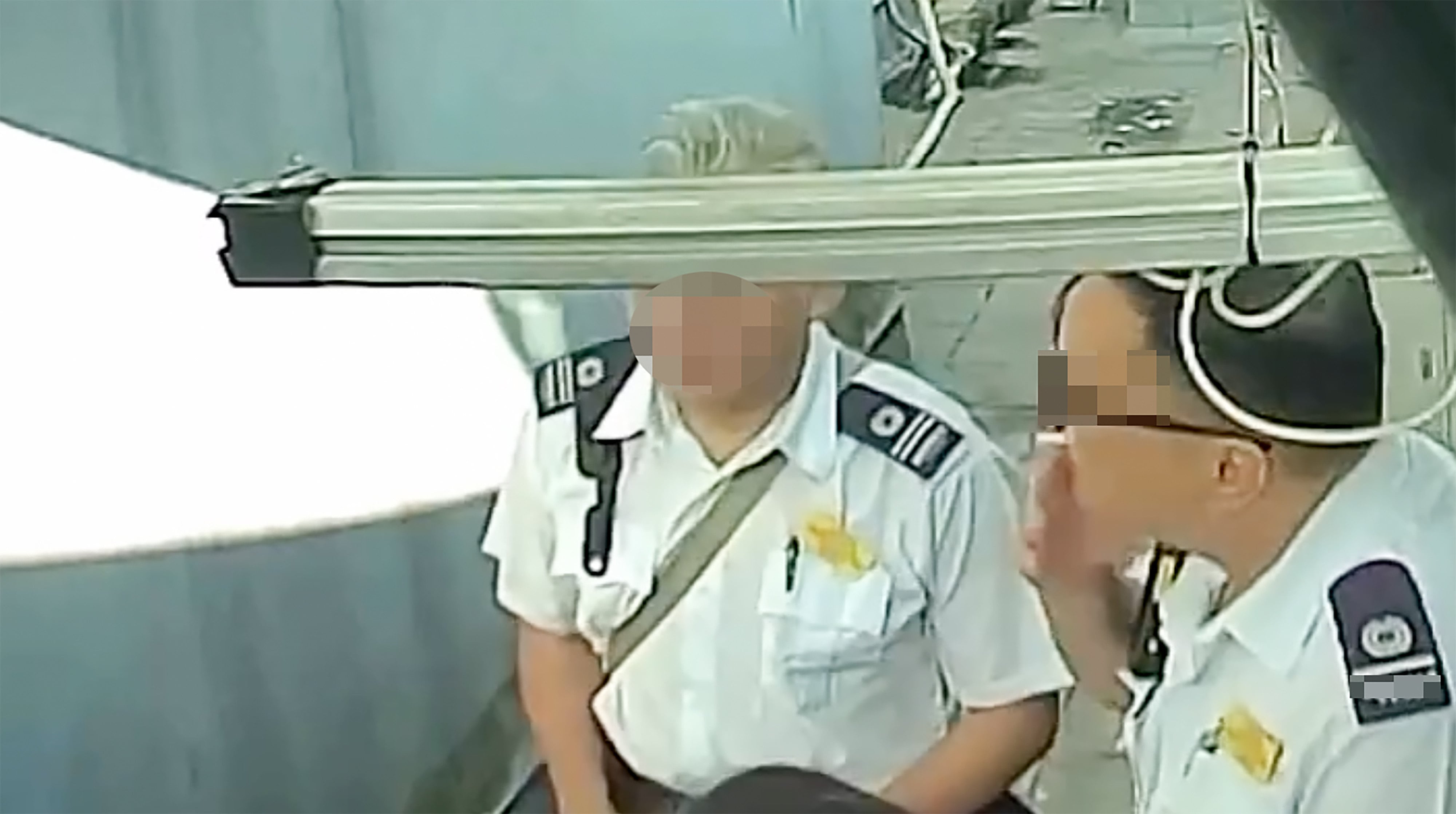 A screengrab from an online clip showing two hygiene officers smoking. Photo: Threads/janicekklove3